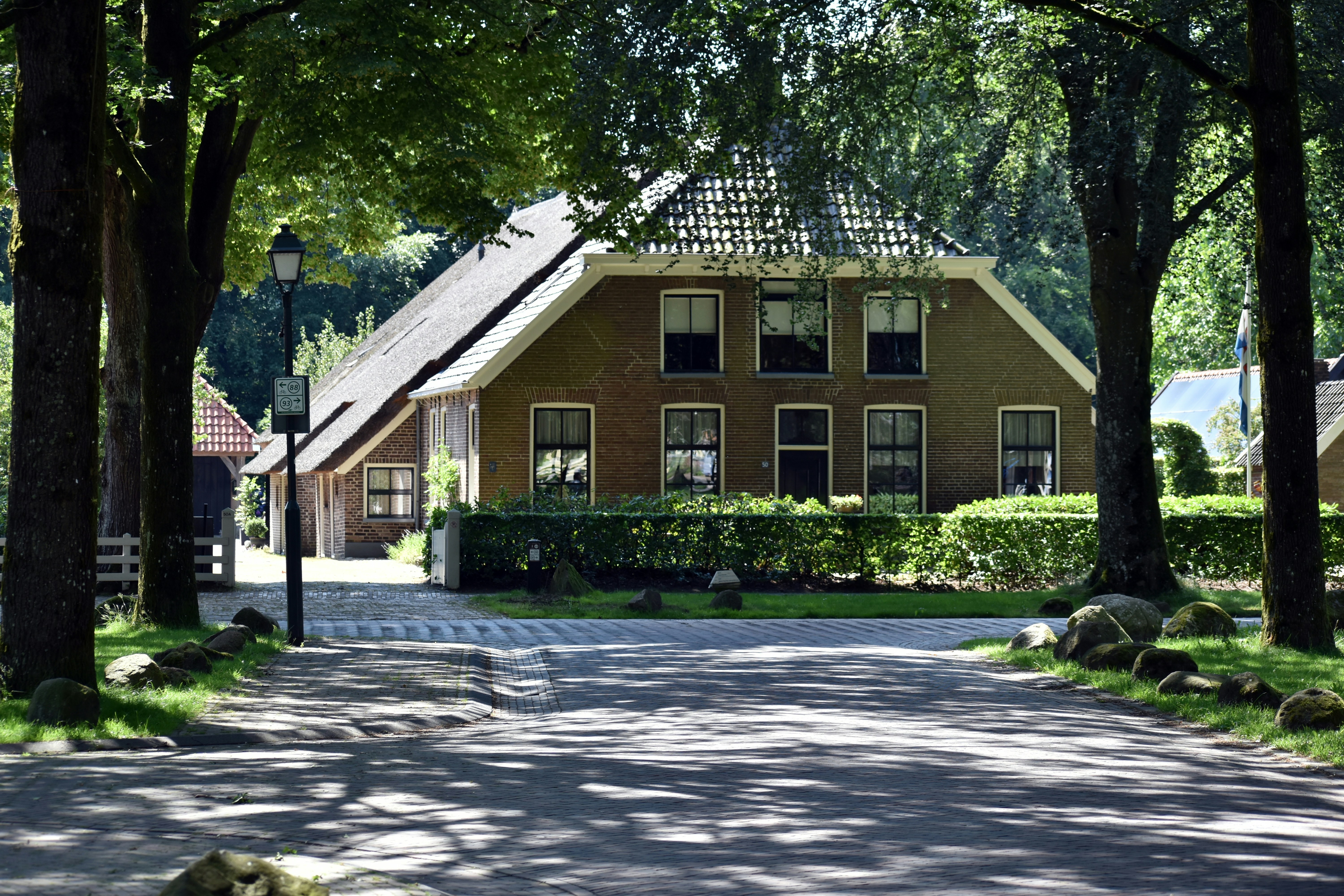 An illustrative photo of a house in the middle of a road.