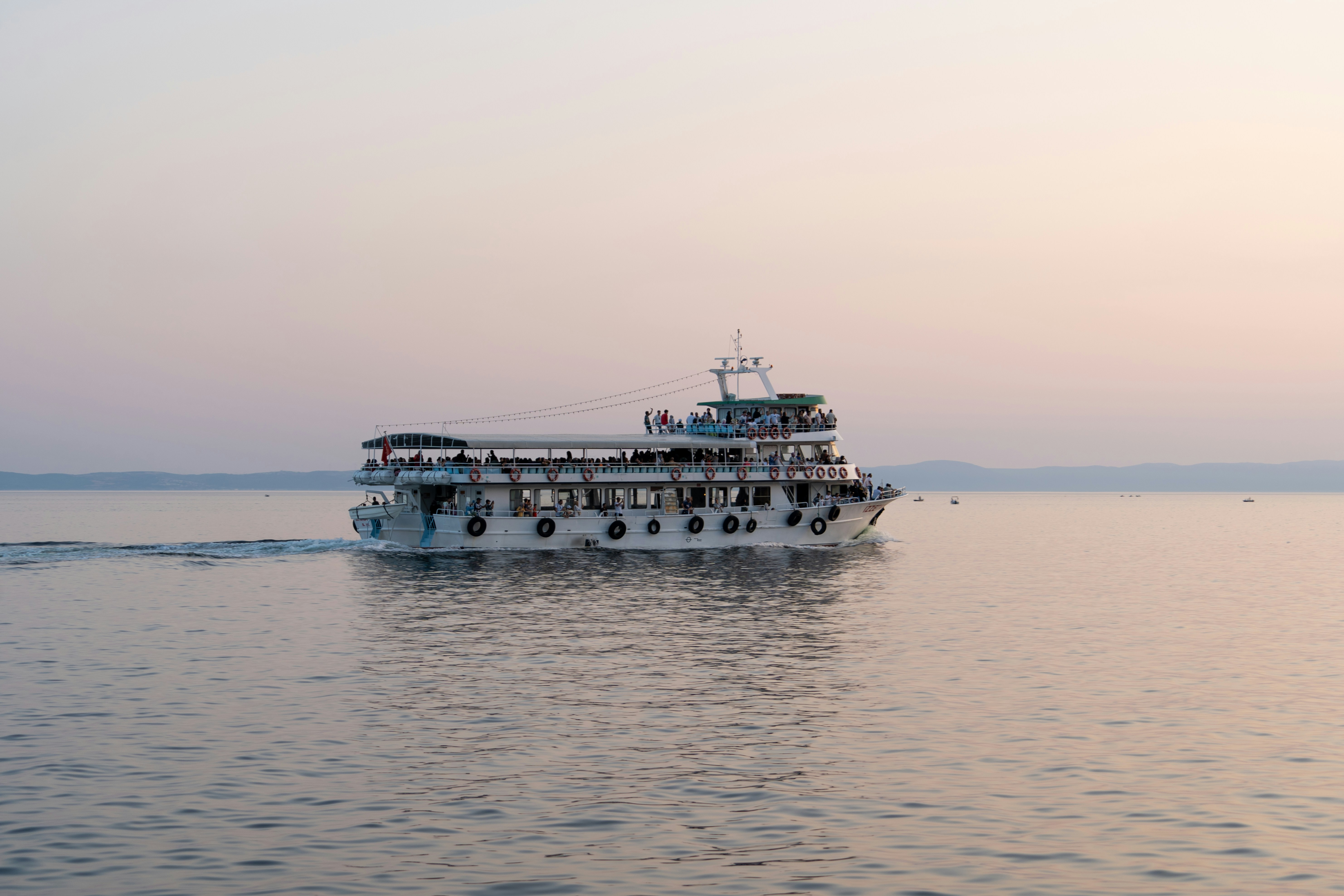Photo by Unsplash An illustrative photo of a large boat filled with people in a body of water