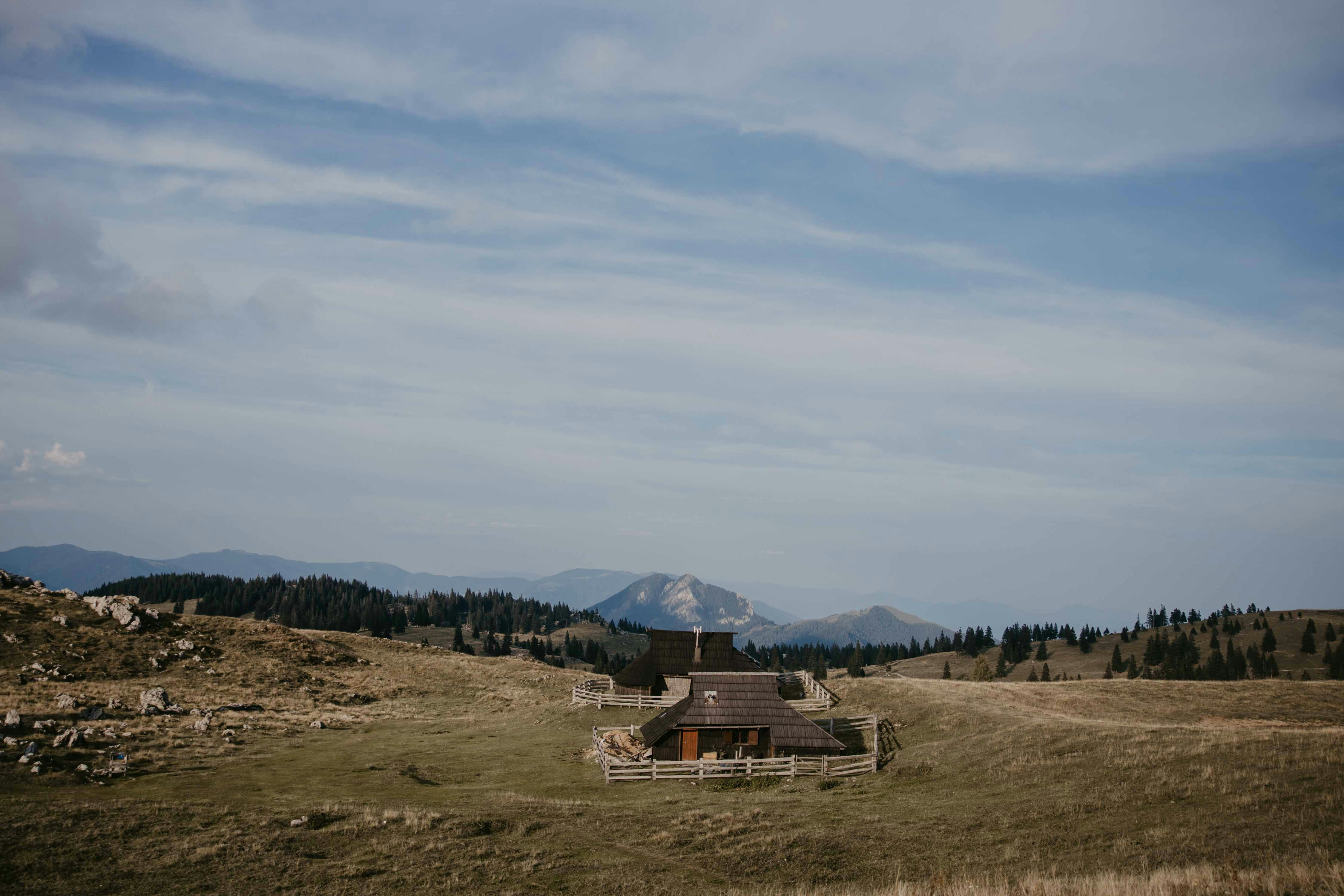 An illustrative photo of a building in a field.