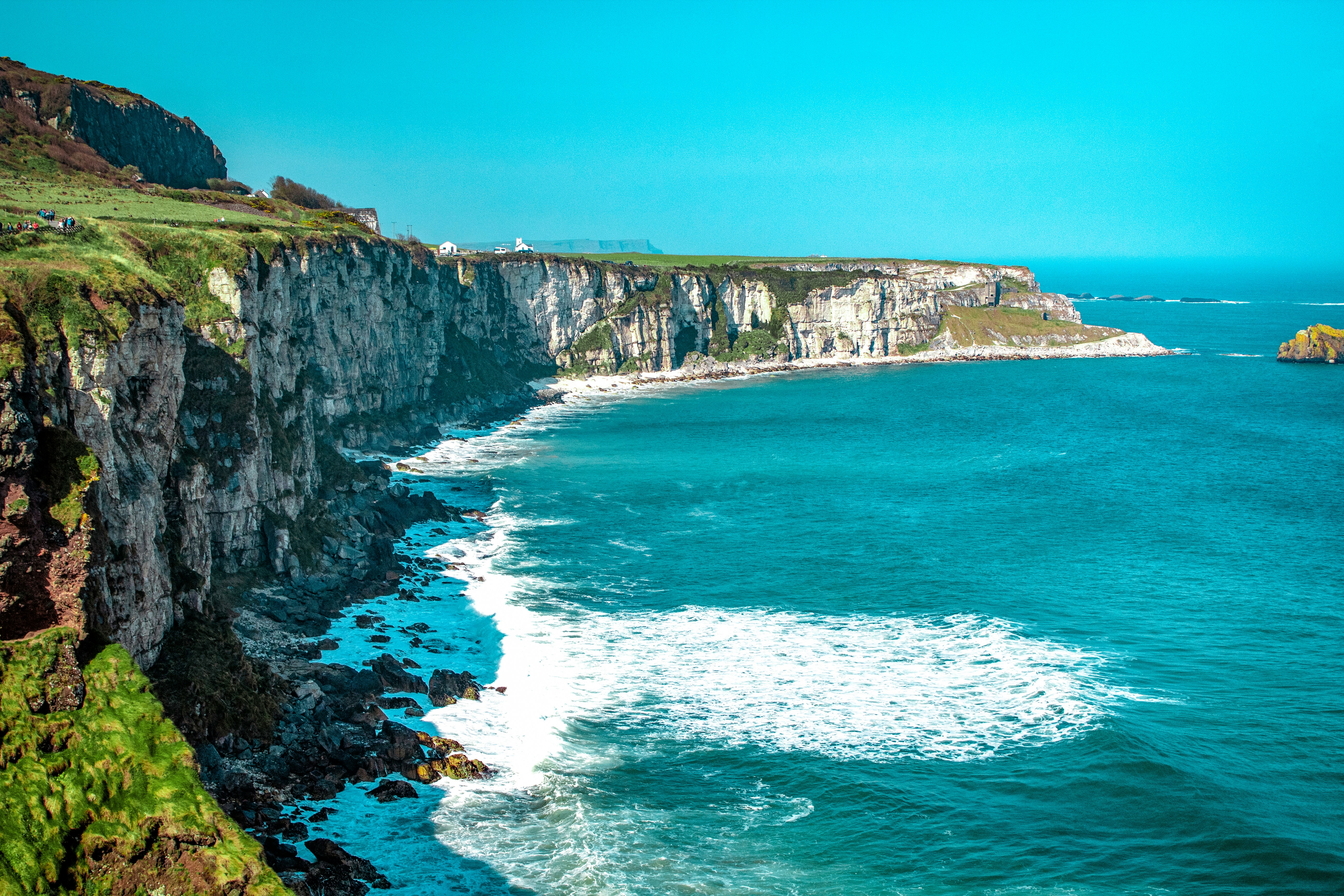 An illustrative photo of a white rock cliff beside body of water