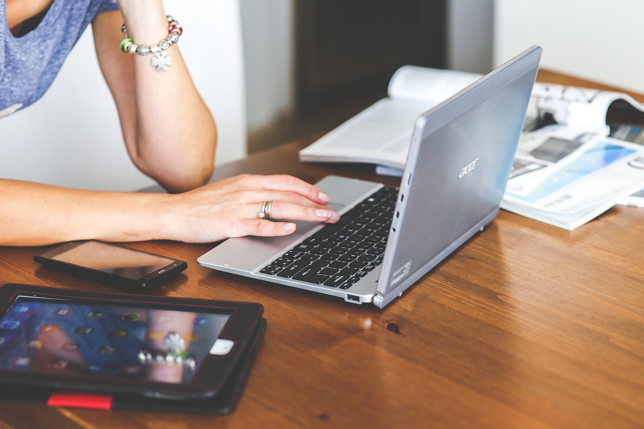 Photo by Pixabay An illustrative photo of a person working on the laptop with a phone and a tablet on the table