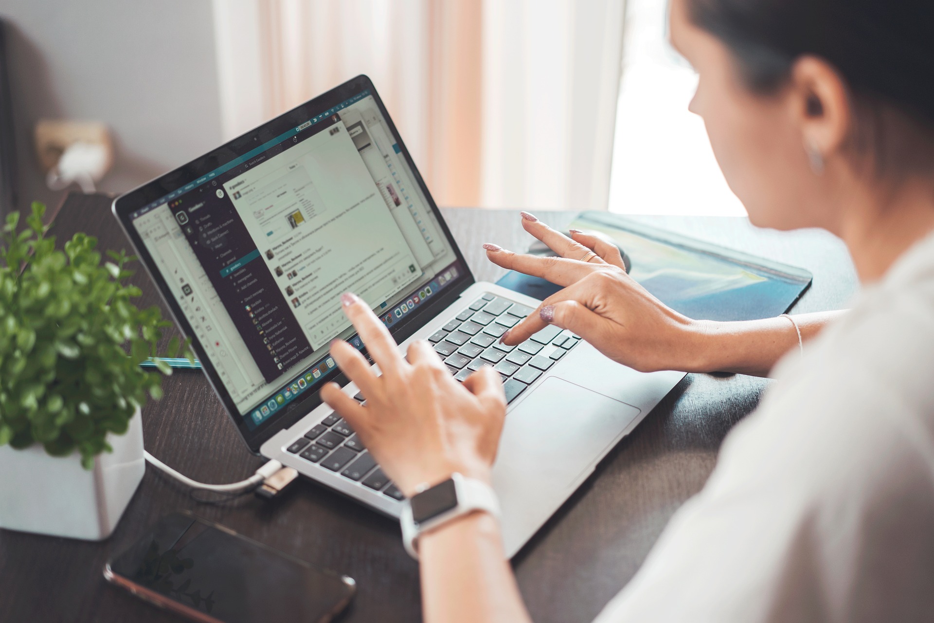 An illustrative photo of a person teleworking on a laptop