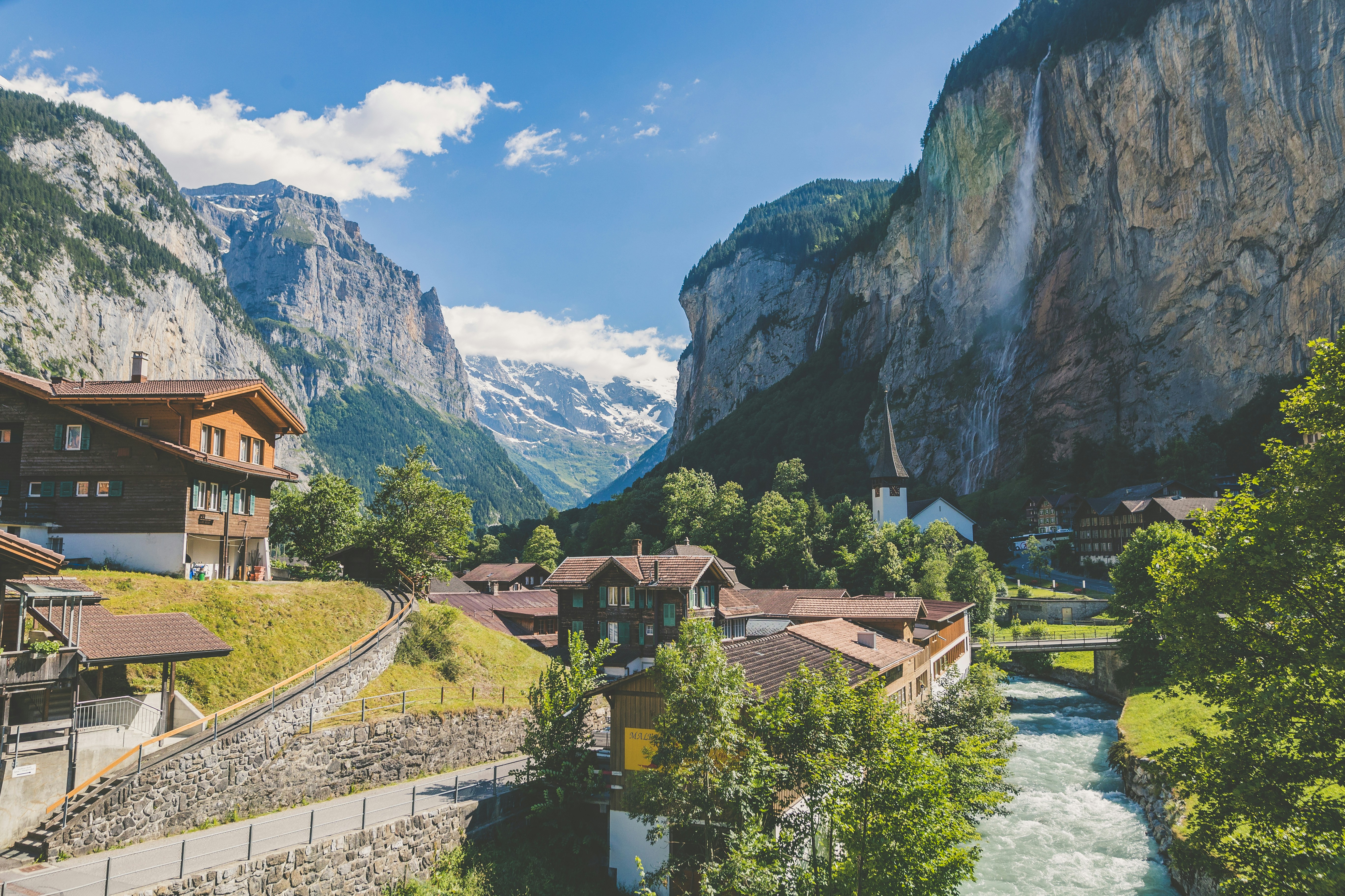 An illustrative photo of houses near a valley with trees