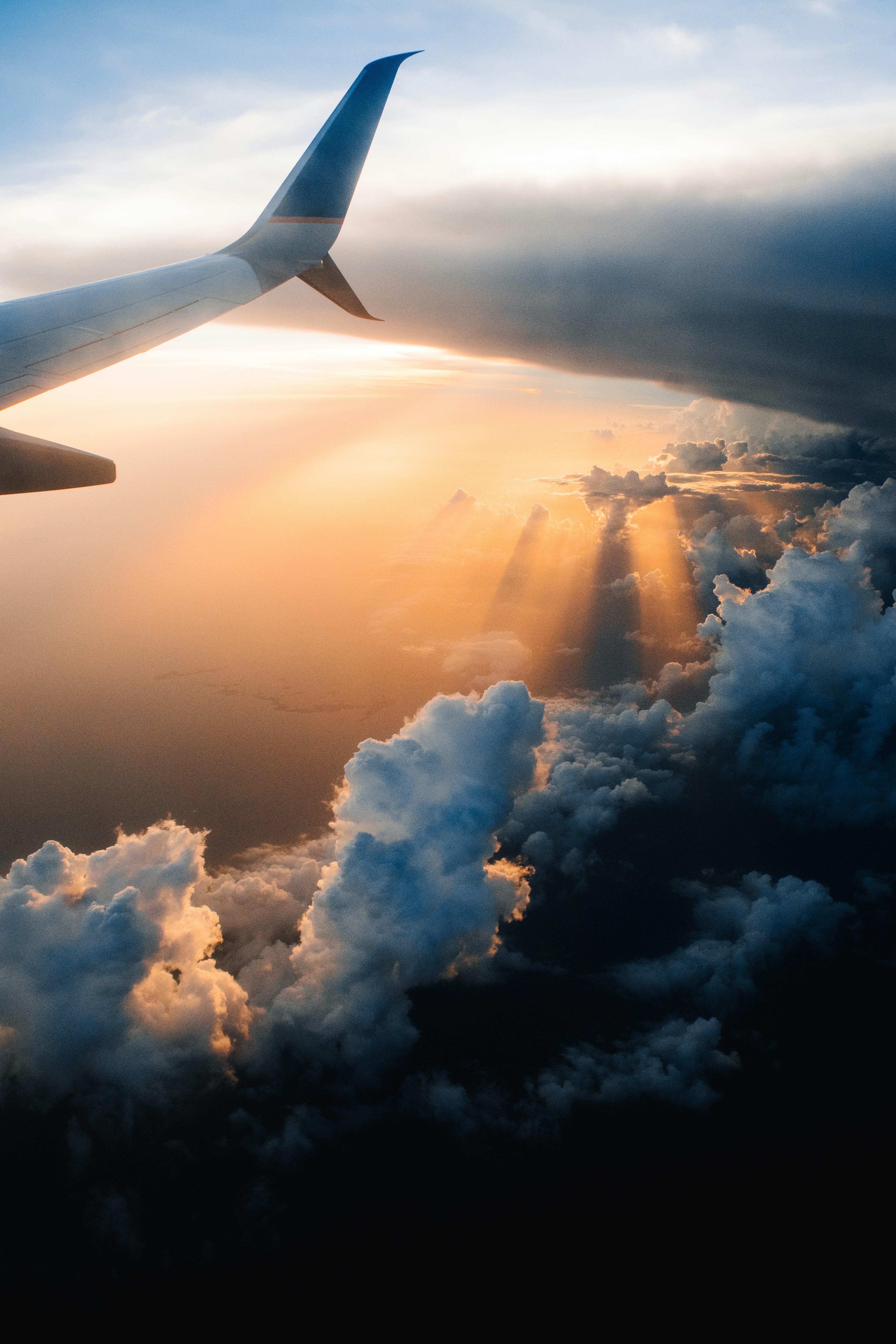 Photo by Unsplash An illustrative photo of a plane in the sky in the light of sunset