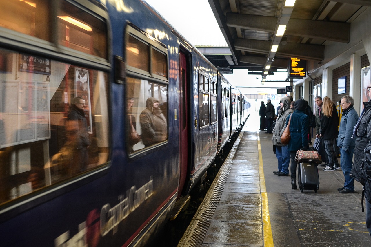 An illustrative photo of passengers waiting on a platform as a train arrives