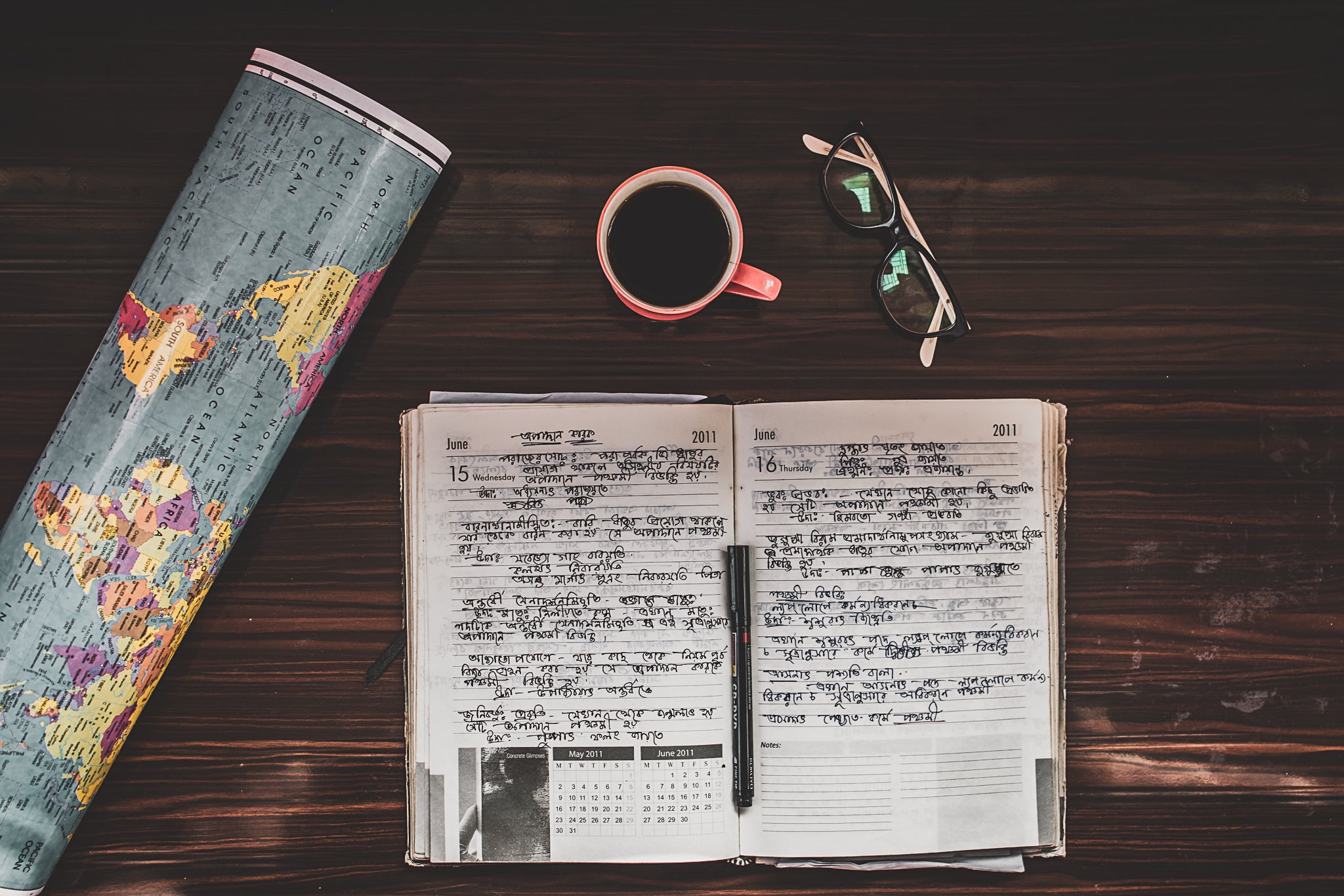 Photo by Shopify An illustrative photo of a map and a notebook on the wooden table