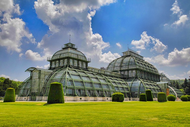 An illustrative photo of a large, ornate greenhouse with classic architectural design.