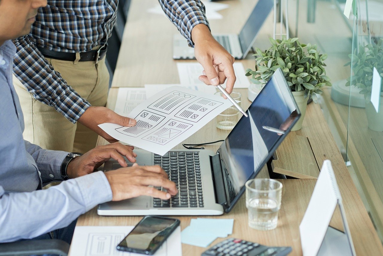 An illustrative photo of two people collaborating in a professional setting.