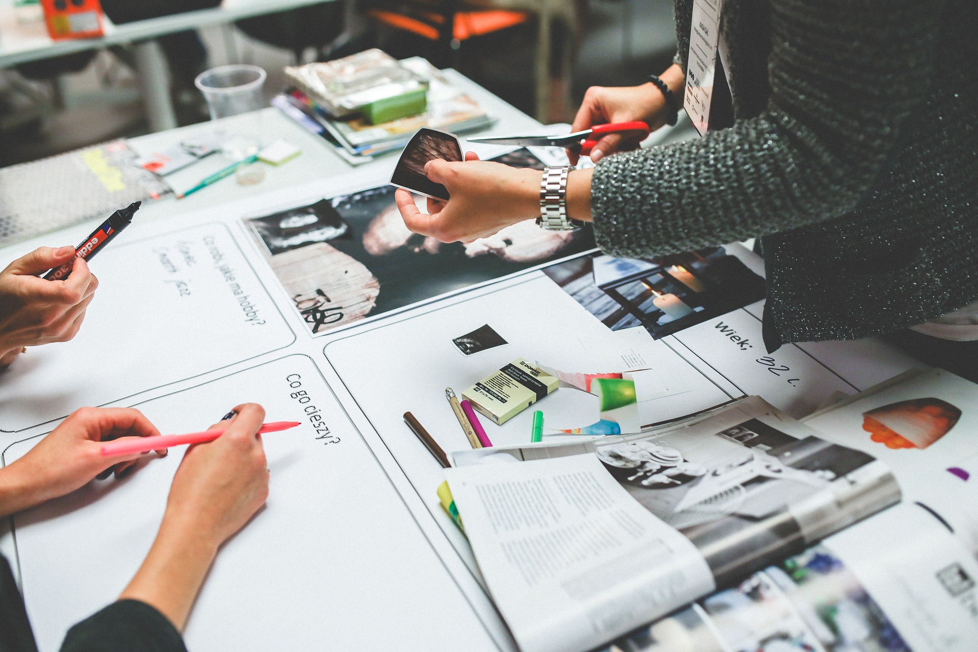 An illustrative photo of a collaborative work environment with multiple people gathered around a table.