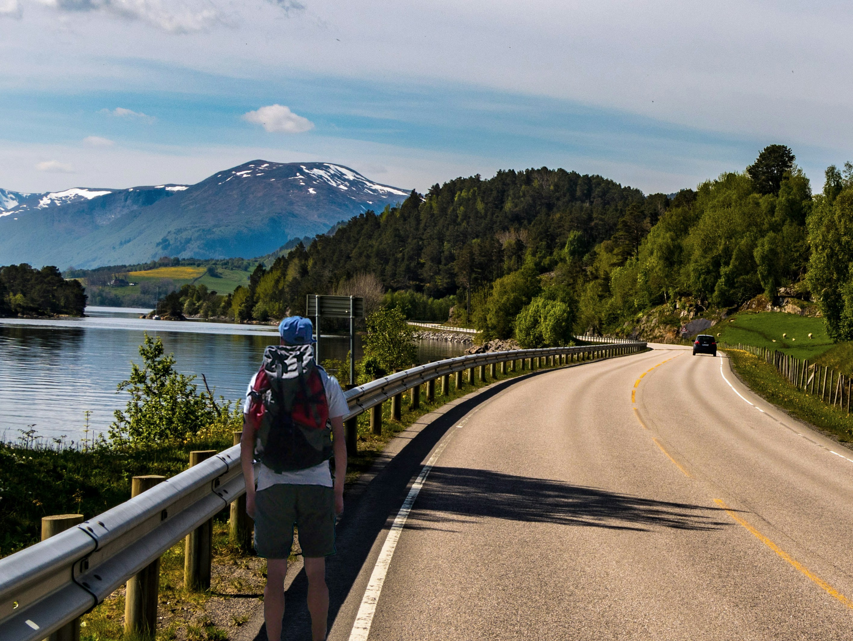 An illustrative photo of a person walking on gray concrete road.