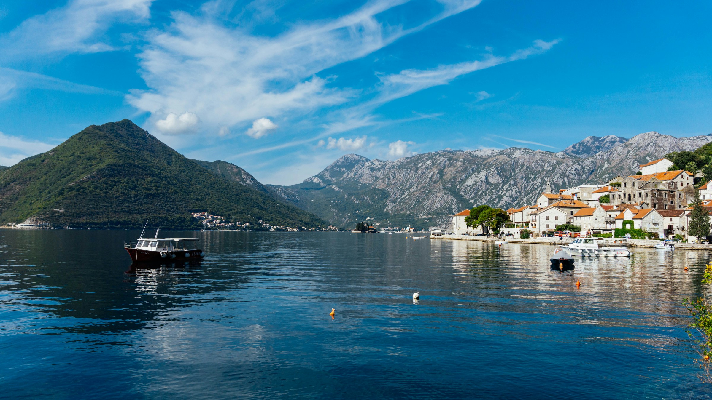 An illustrative photo of a boat floating on top of a body of water.