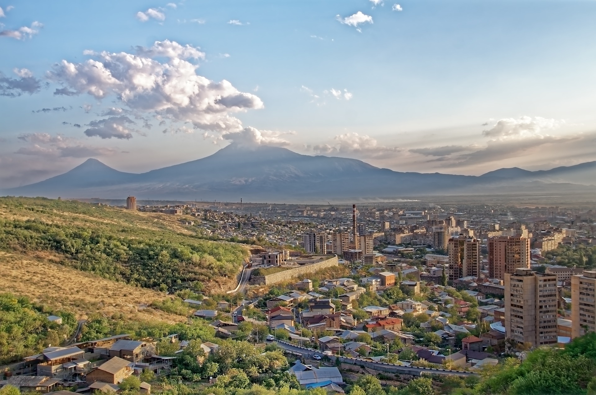 An illustrative photo of a city with mountains in the background