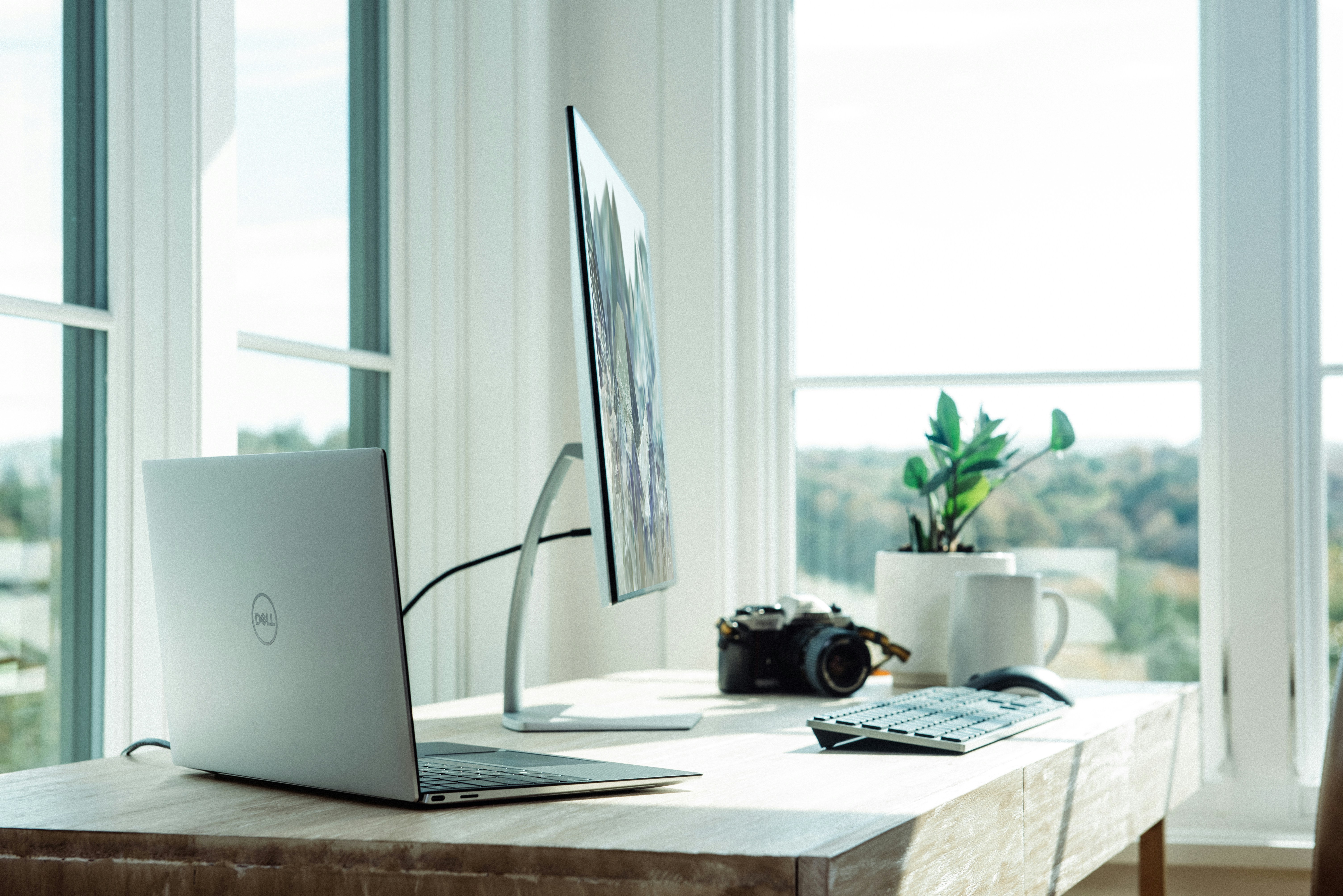 An illustrative photo os a laptop and a computer on white table