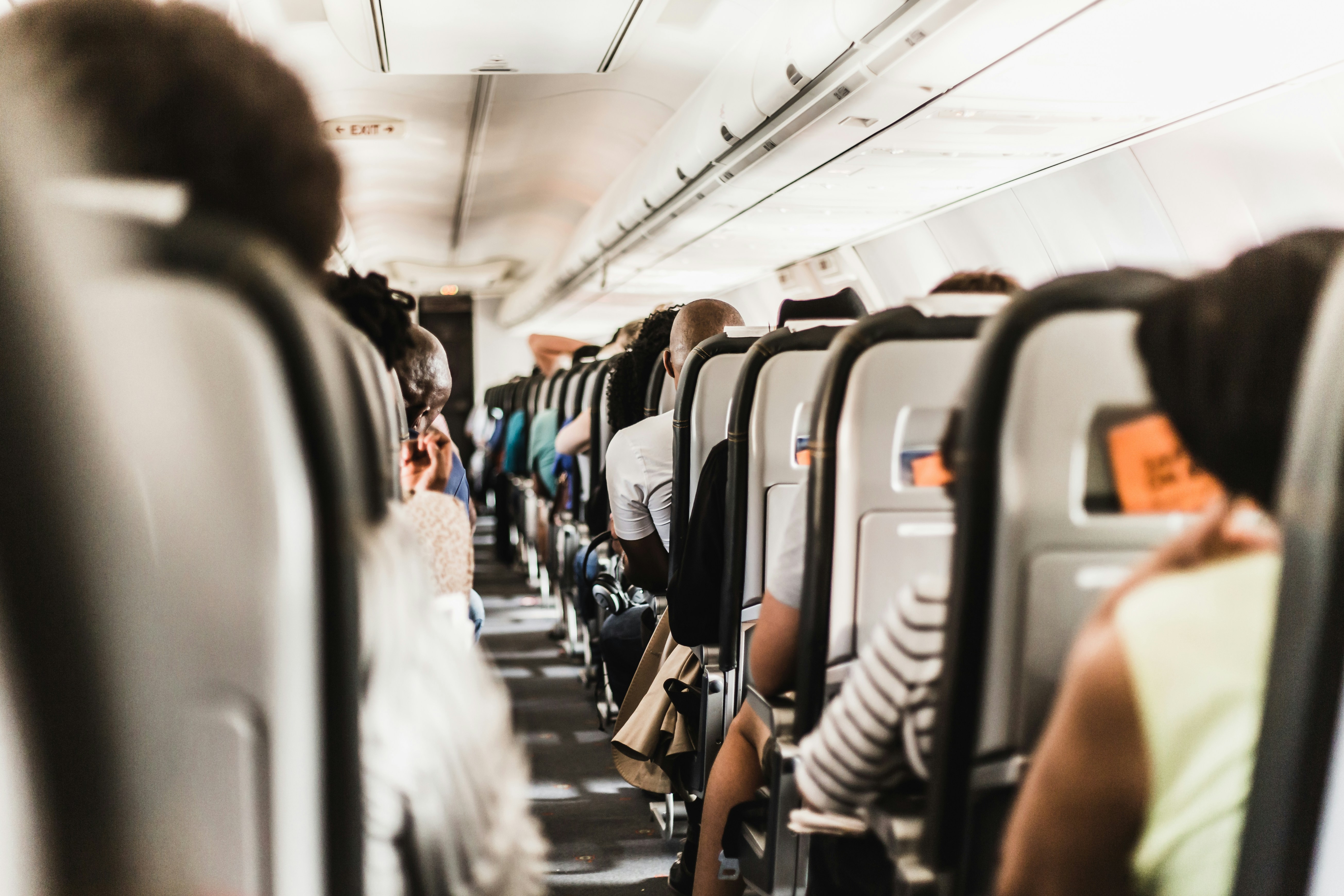 An illustrative photo of people sitting in a airplane