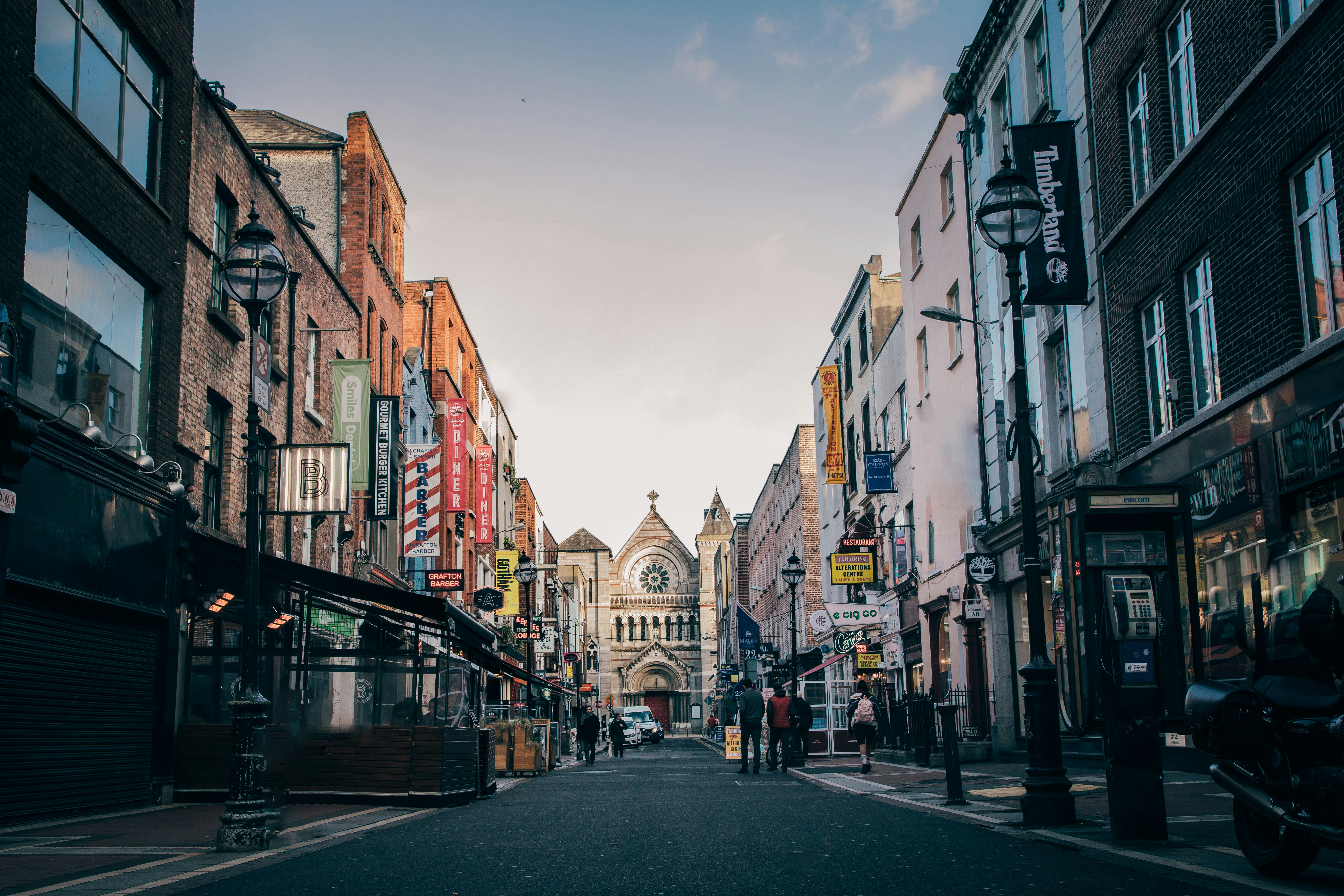 Photo by Unsplash An illustrative photo of buildings and people walking down the street.