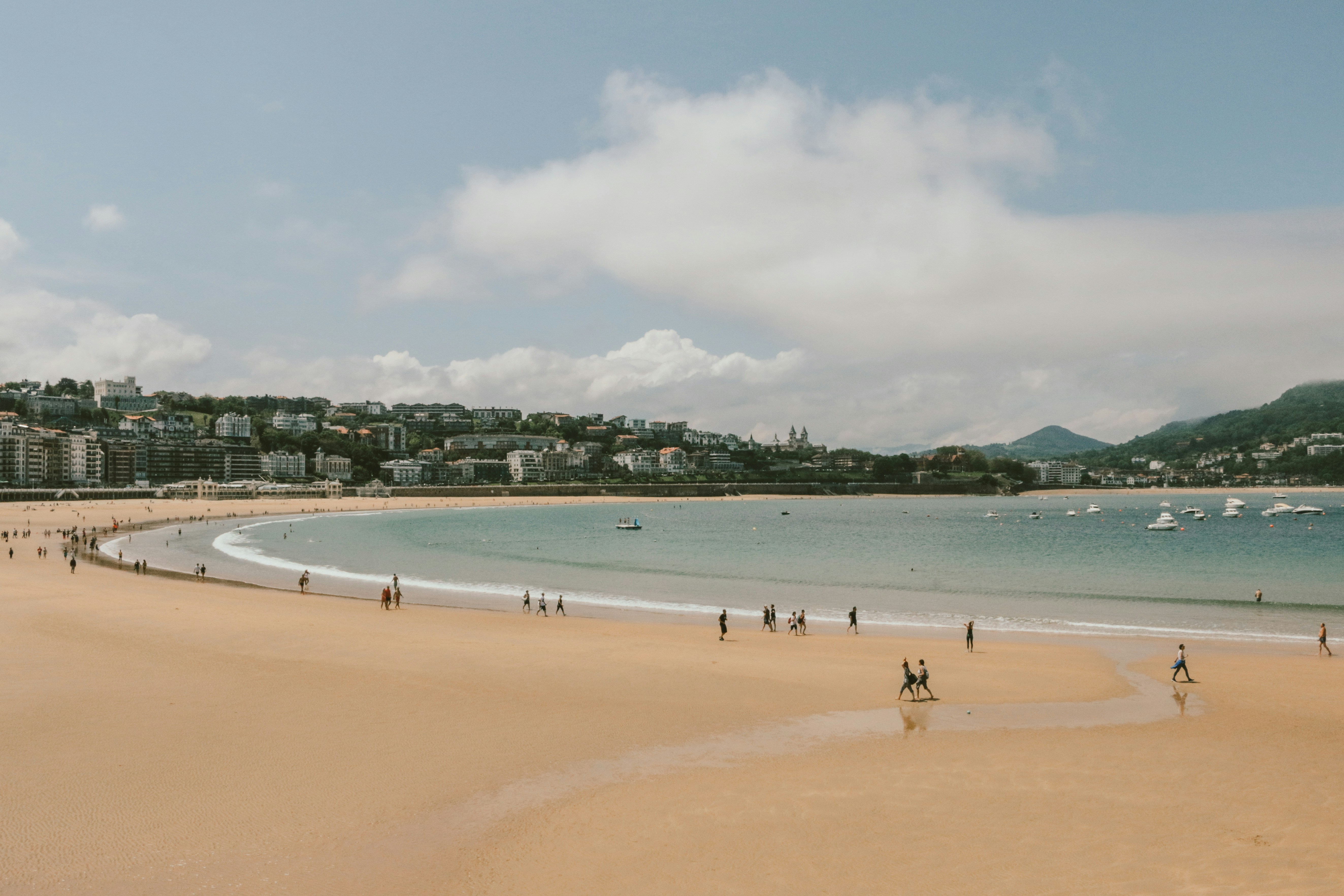 An illustrative photo of people walking on the beach