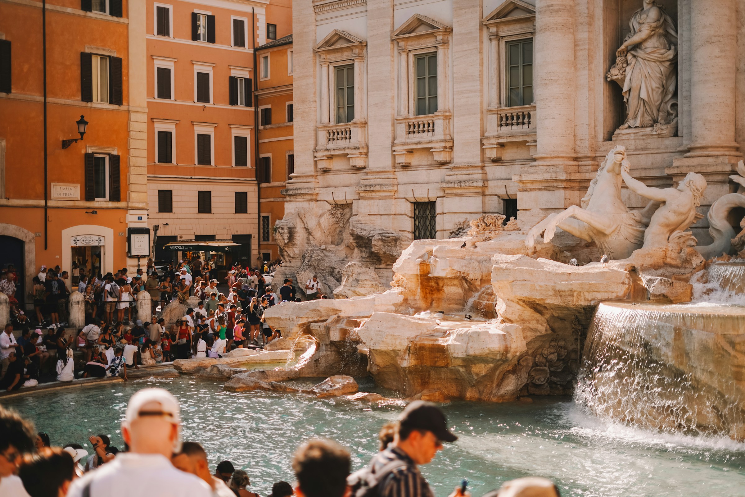 Photo by Unsplash An illustrative photo of a crowd of people standing around a fountain.