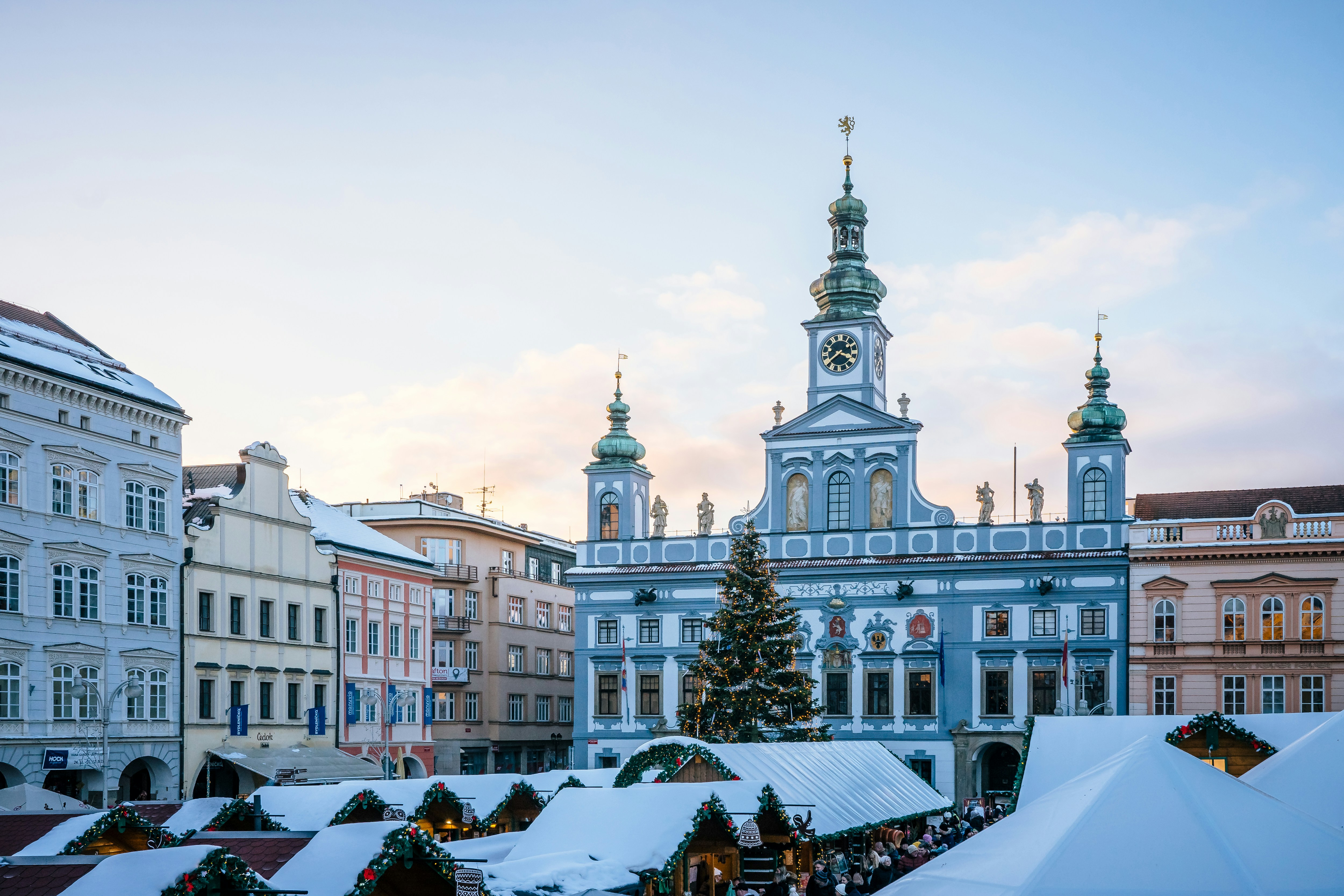 An illustrative photo of a large building with a Christmas tree in front of it