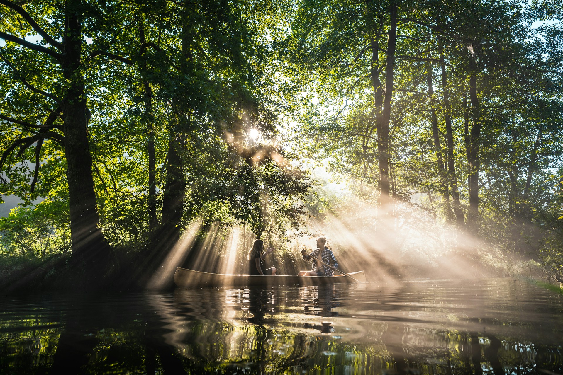 Photo by Unsplash An illustrative photo of people on the boat in a river in a forest