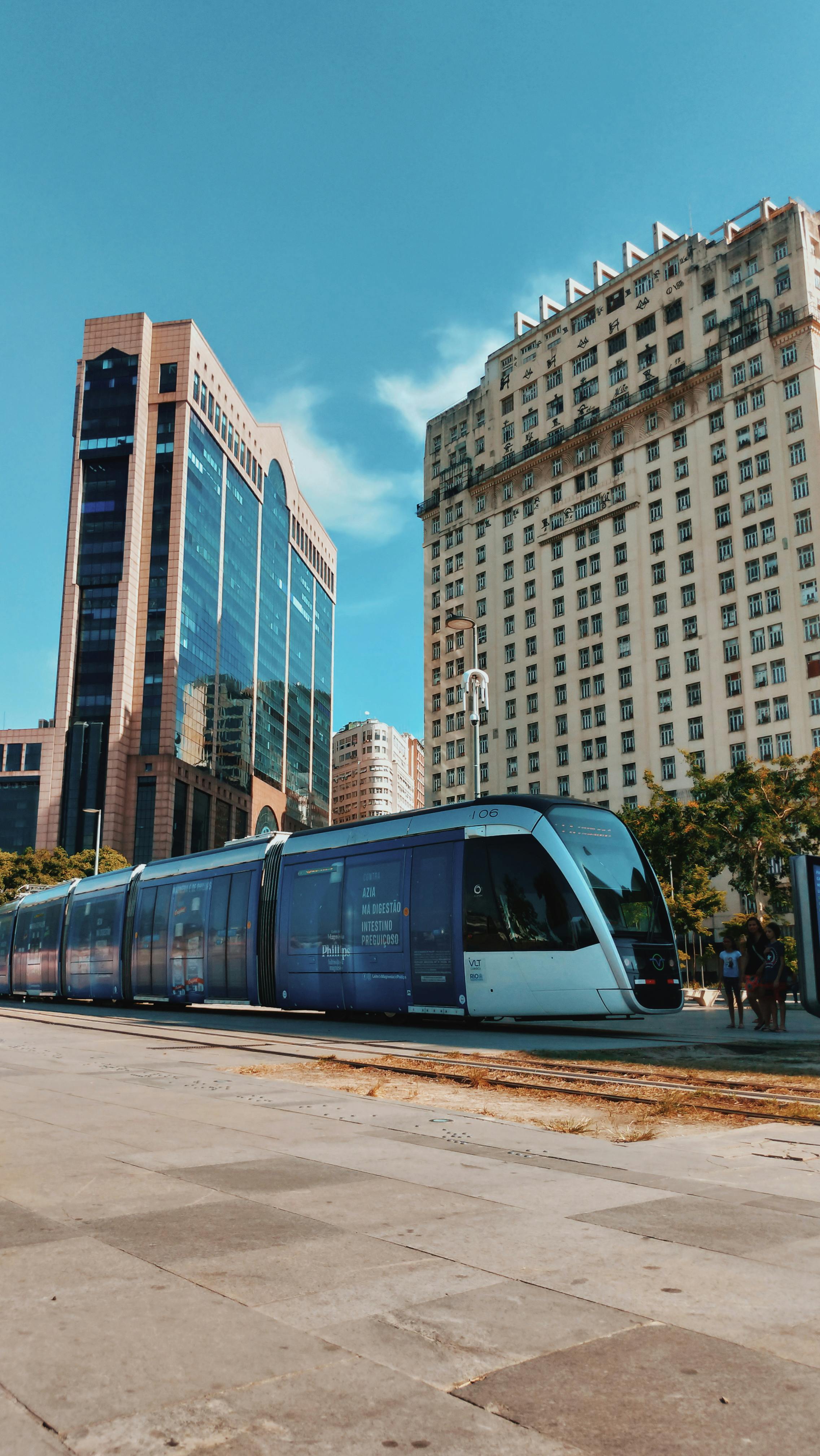 An illustrative photo of a train in the city with tall buildings in the background