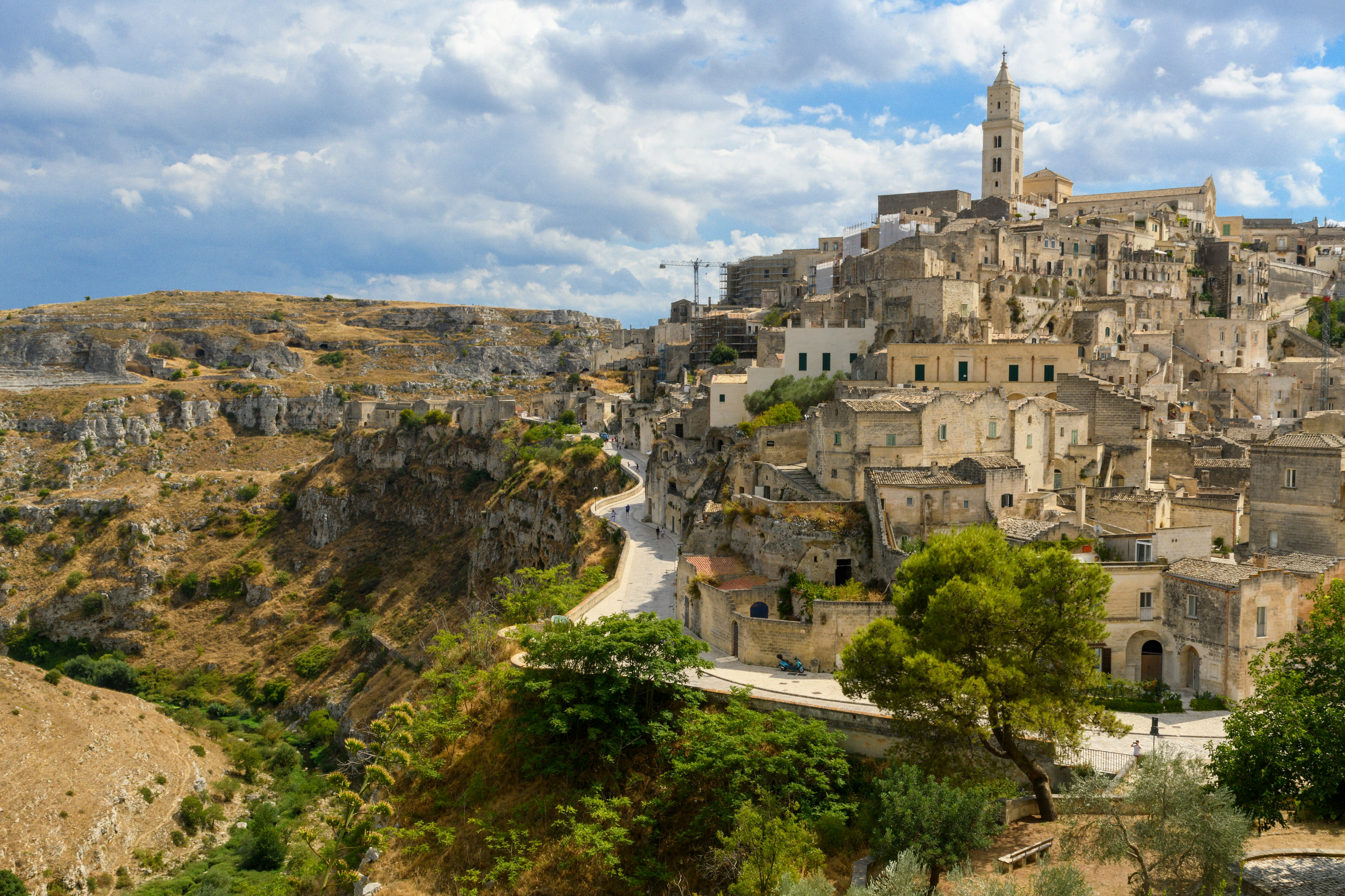 An illustrative photo of a village on a hill with a clock tower on top