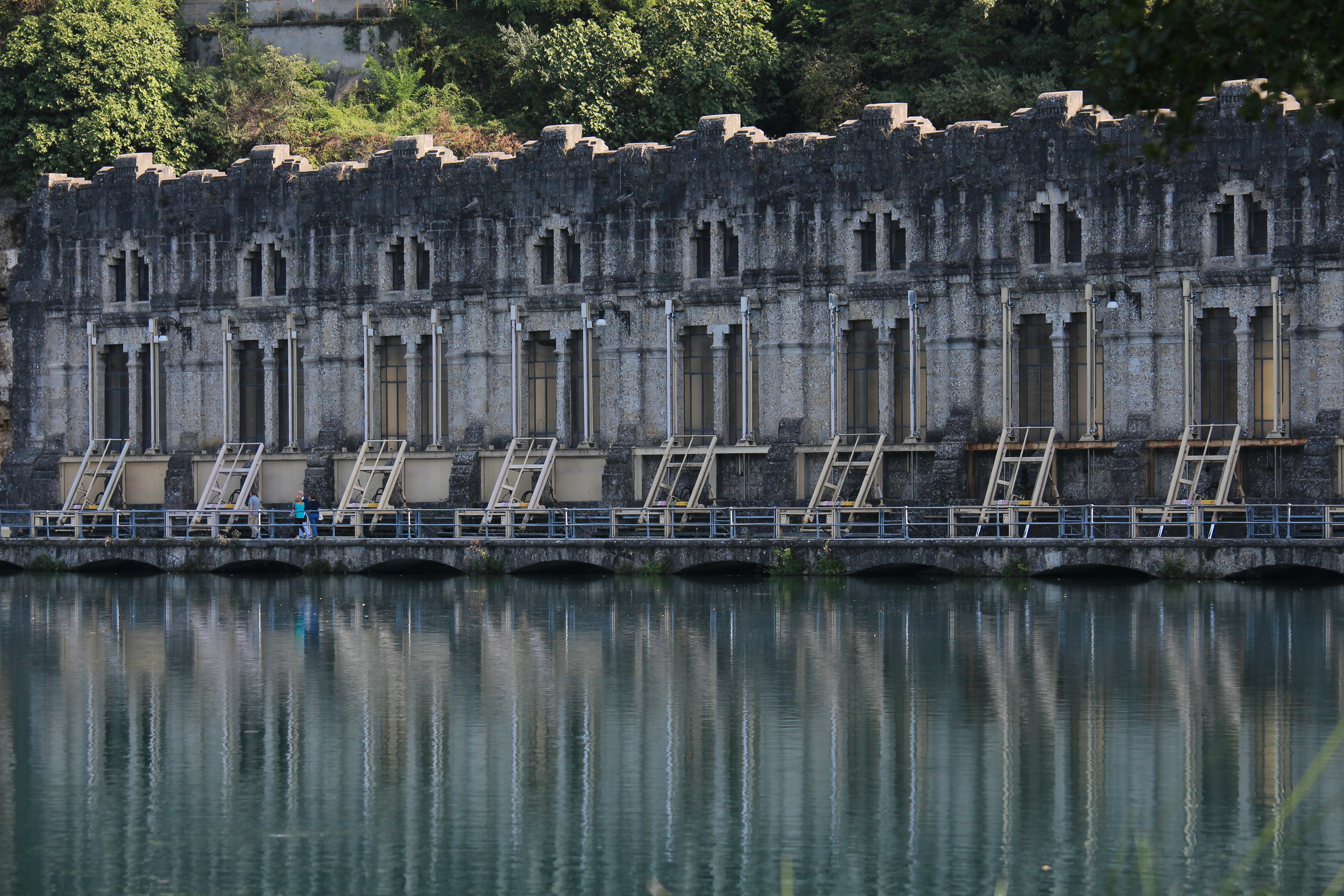 Photo by Unsplash An illustrative photo of a gray concrete building reflection on a body of water