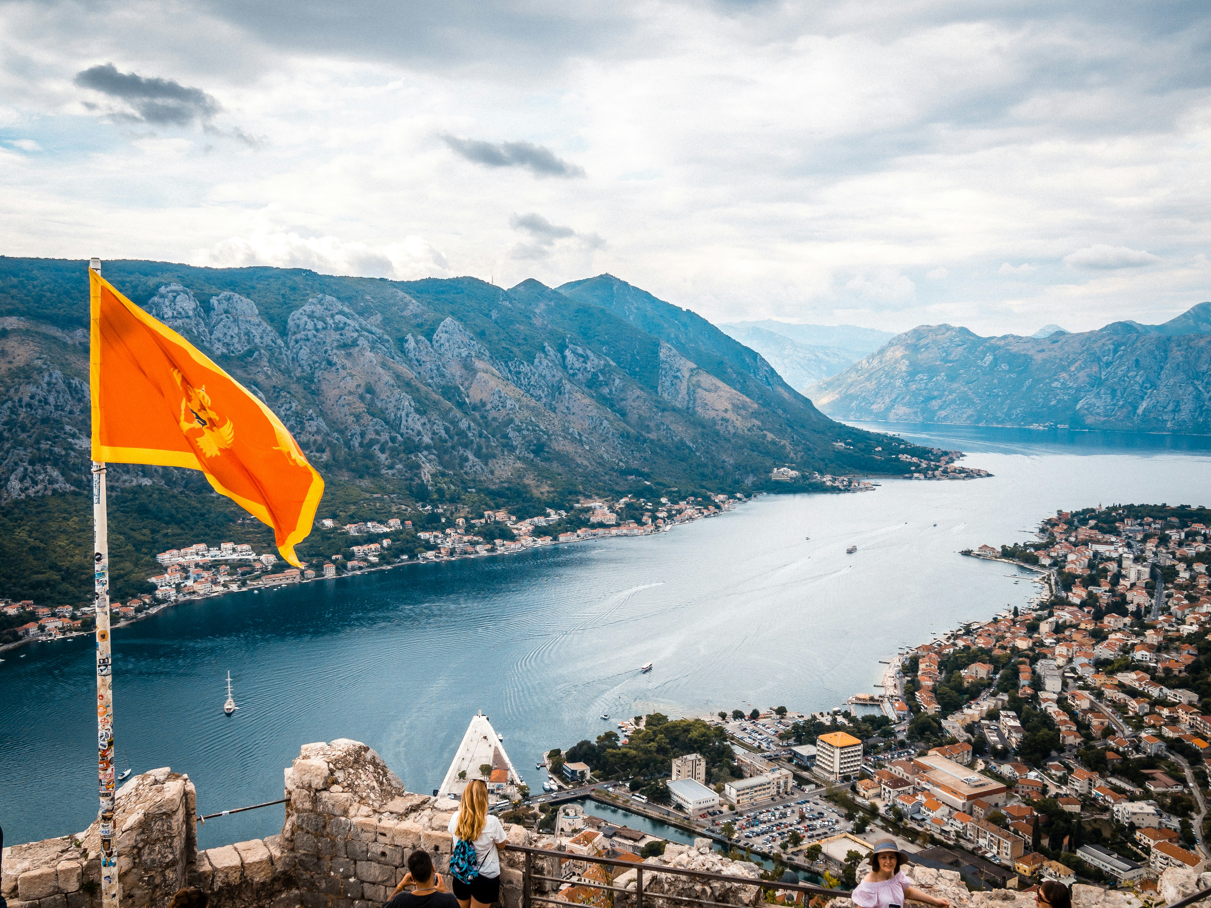An illustrative photo of a view of a lake and mountains from a castle