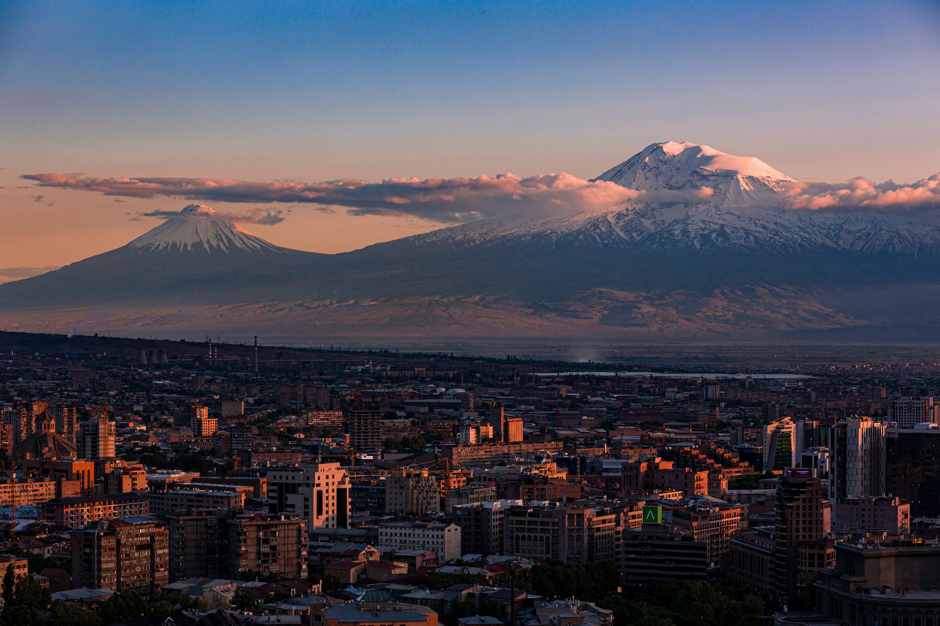 An illustrative photo of a view of a city with mountains in the background