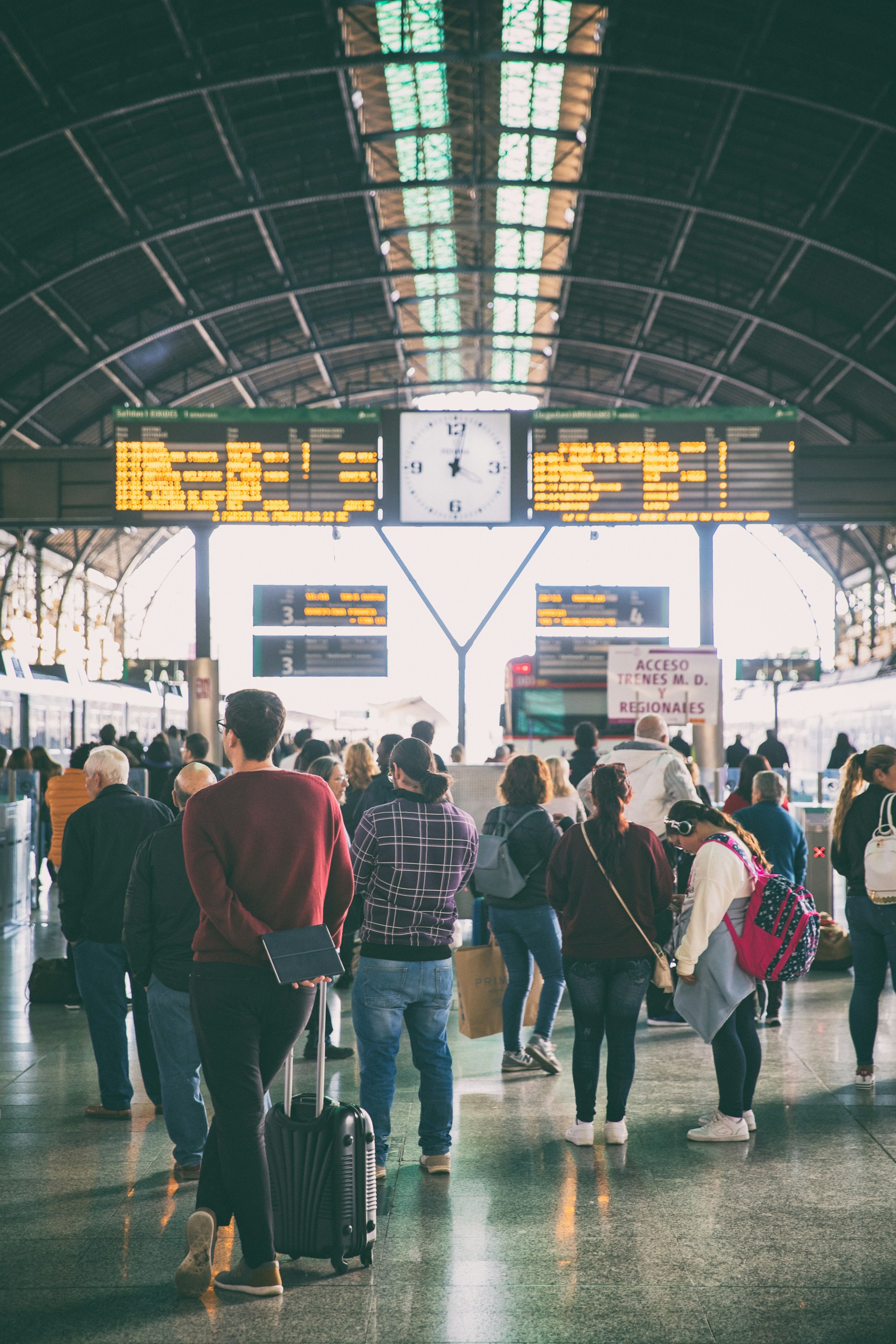 An illustrative photo of people waiting for their trains at a train station