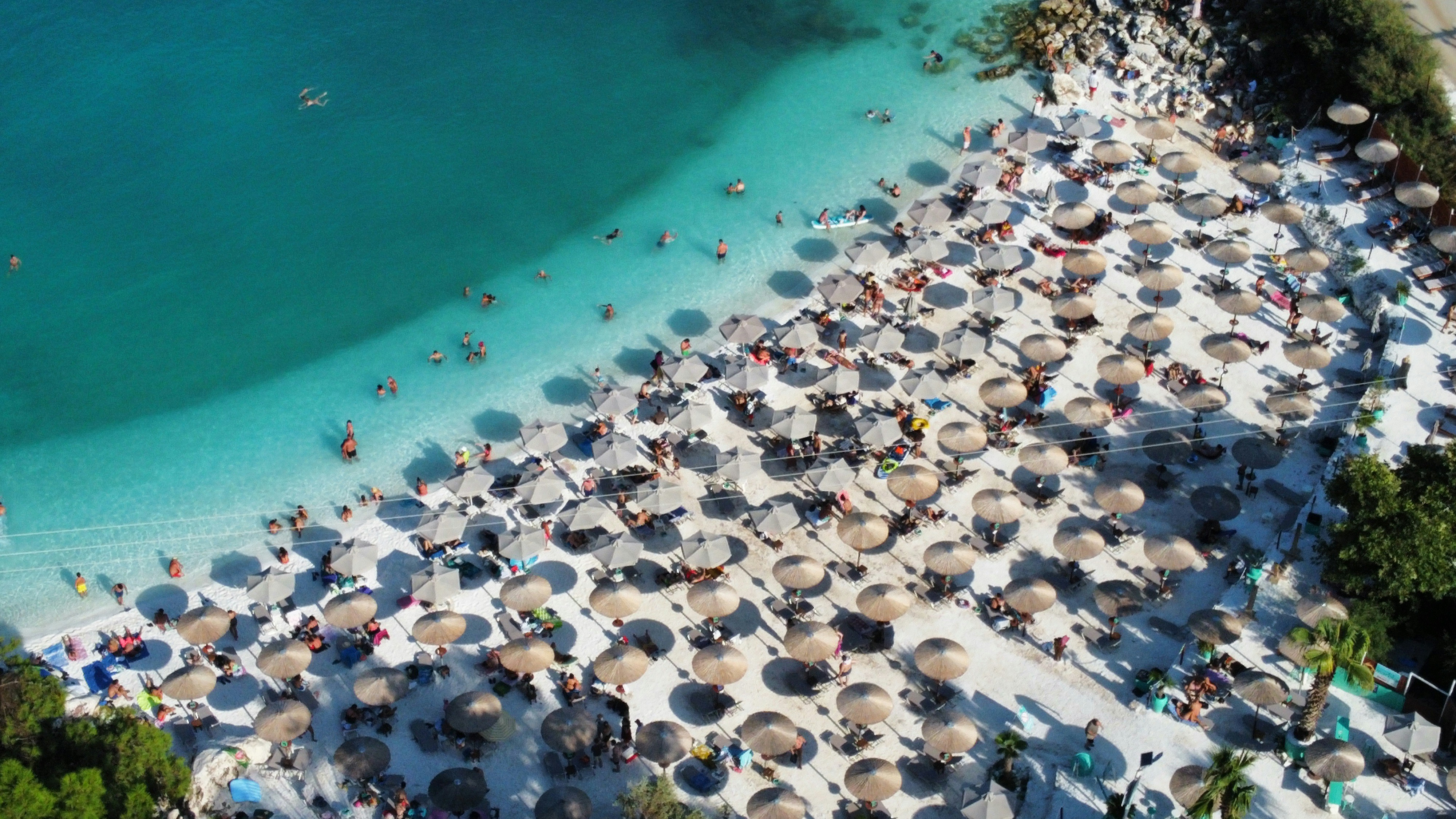 Photo by Unsplash An illustrative photo of a beach with umbrellas full of people