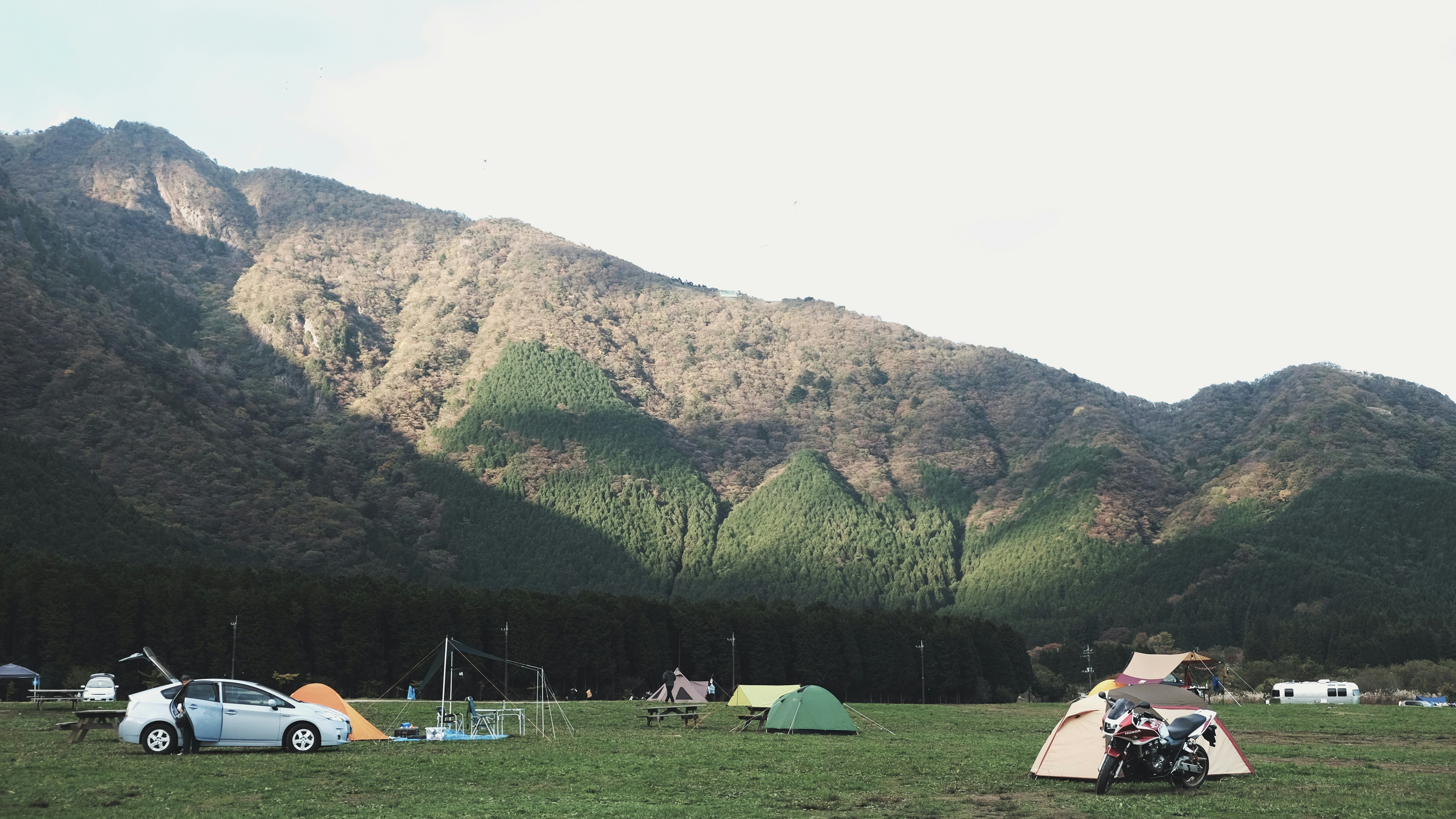 An illustrative photo of dome tents near mountains.