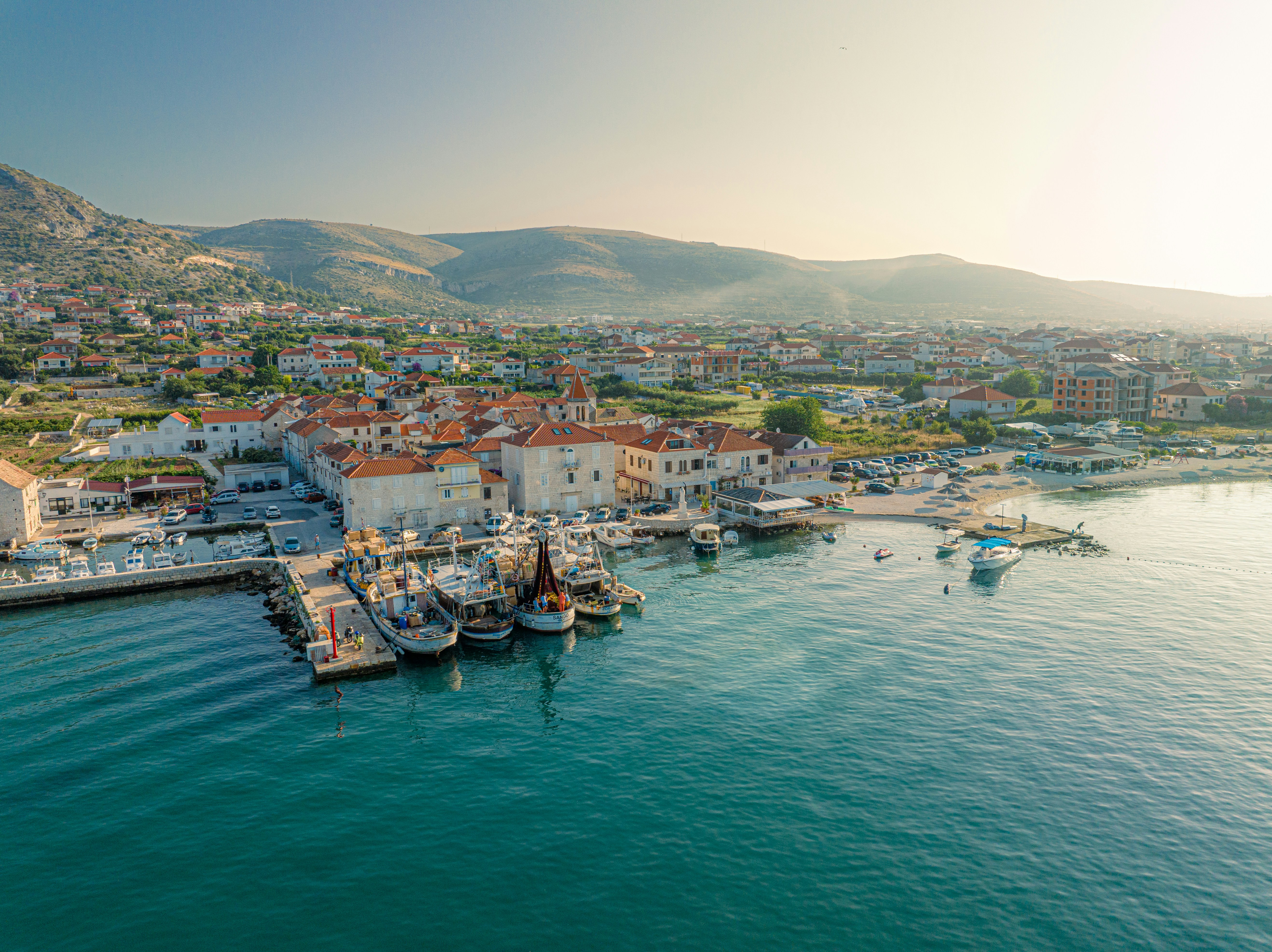 An illustrative photo of a harbor with boats in the water.