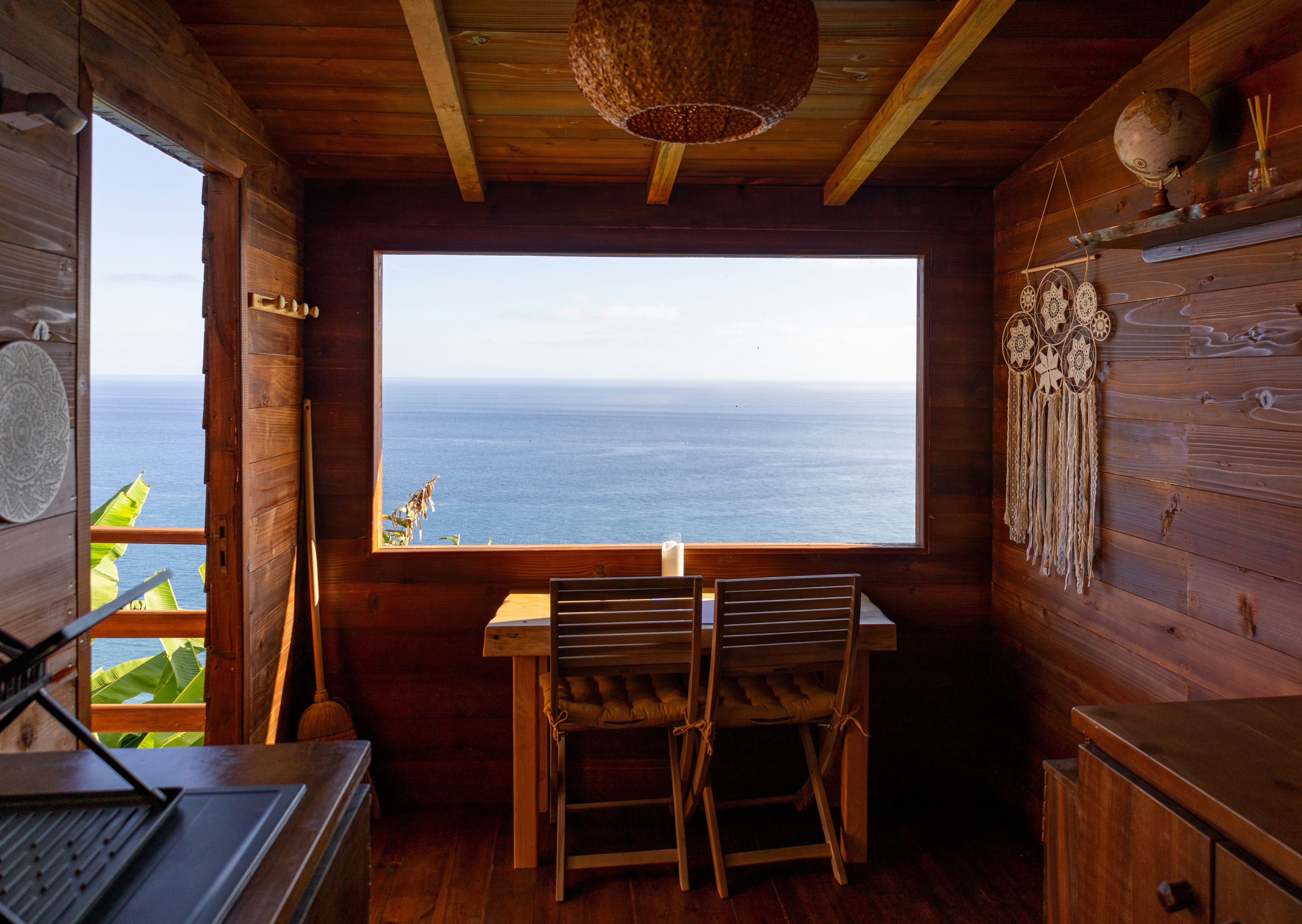 An illustrative photo of a kitchen with a large window with a view of the sea