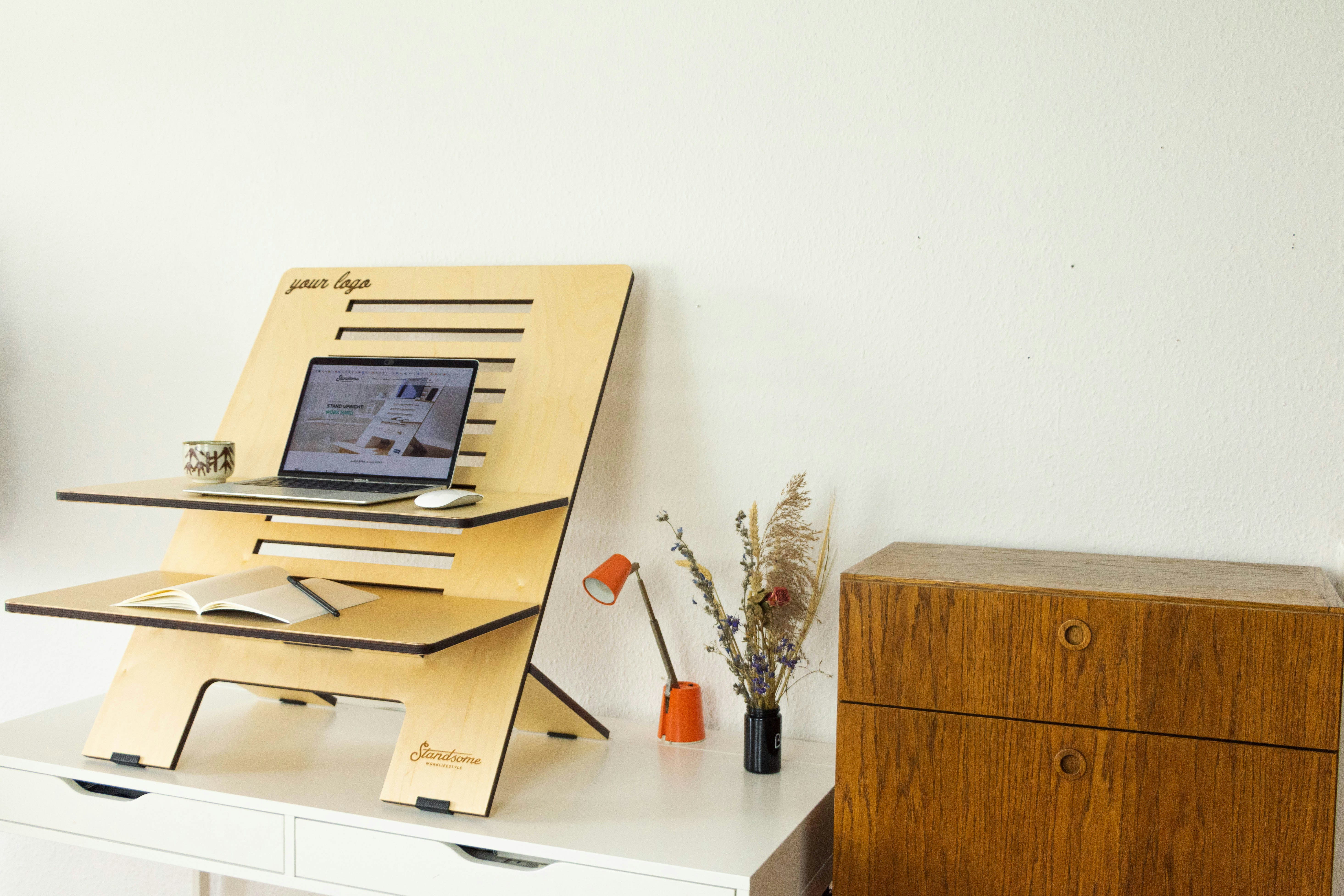An illustrative photo of a desk with a computer on top of it