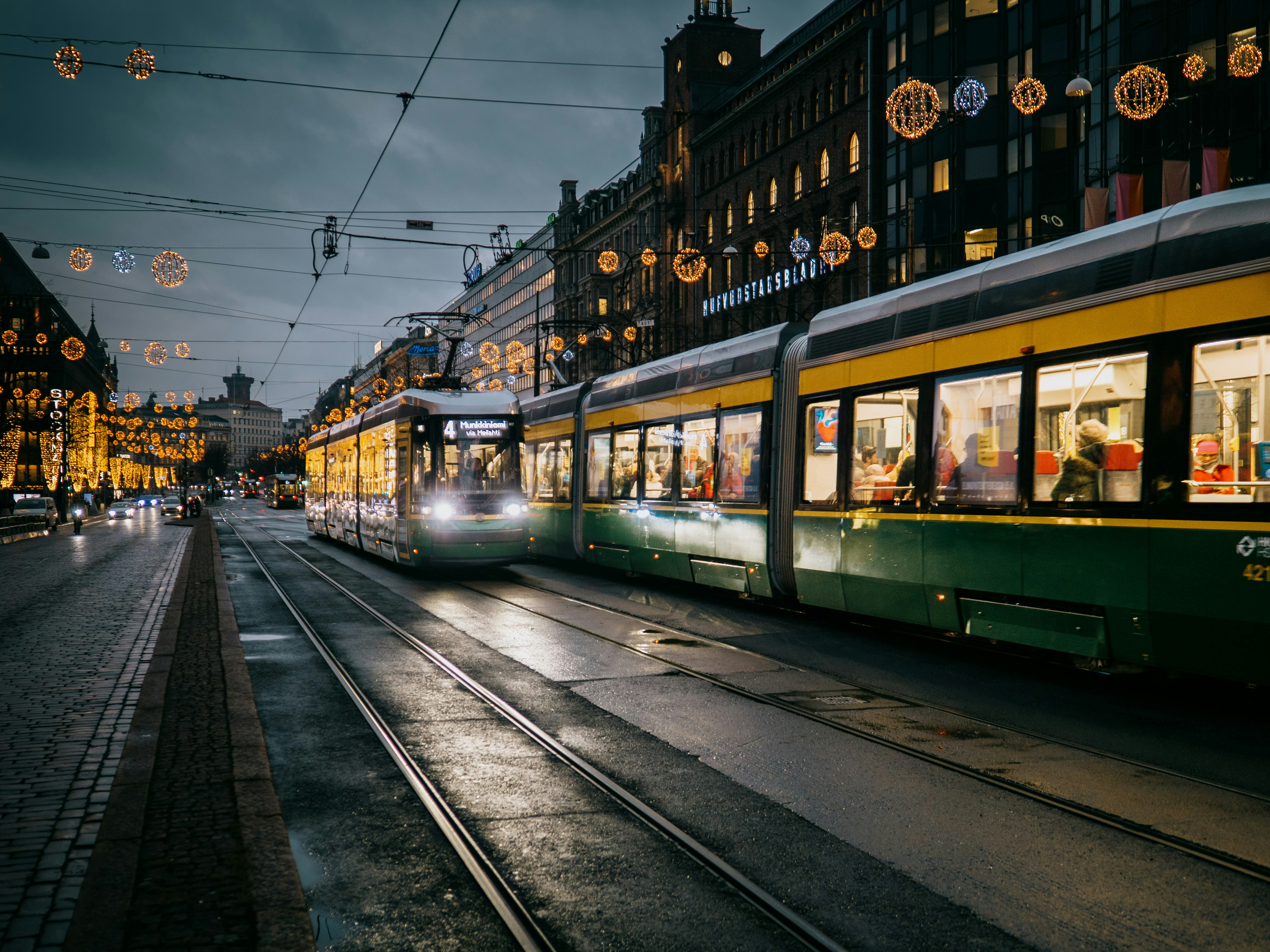 Photo by Unsplash An illustrative photo of a green and white tram on the street in Finland during night time