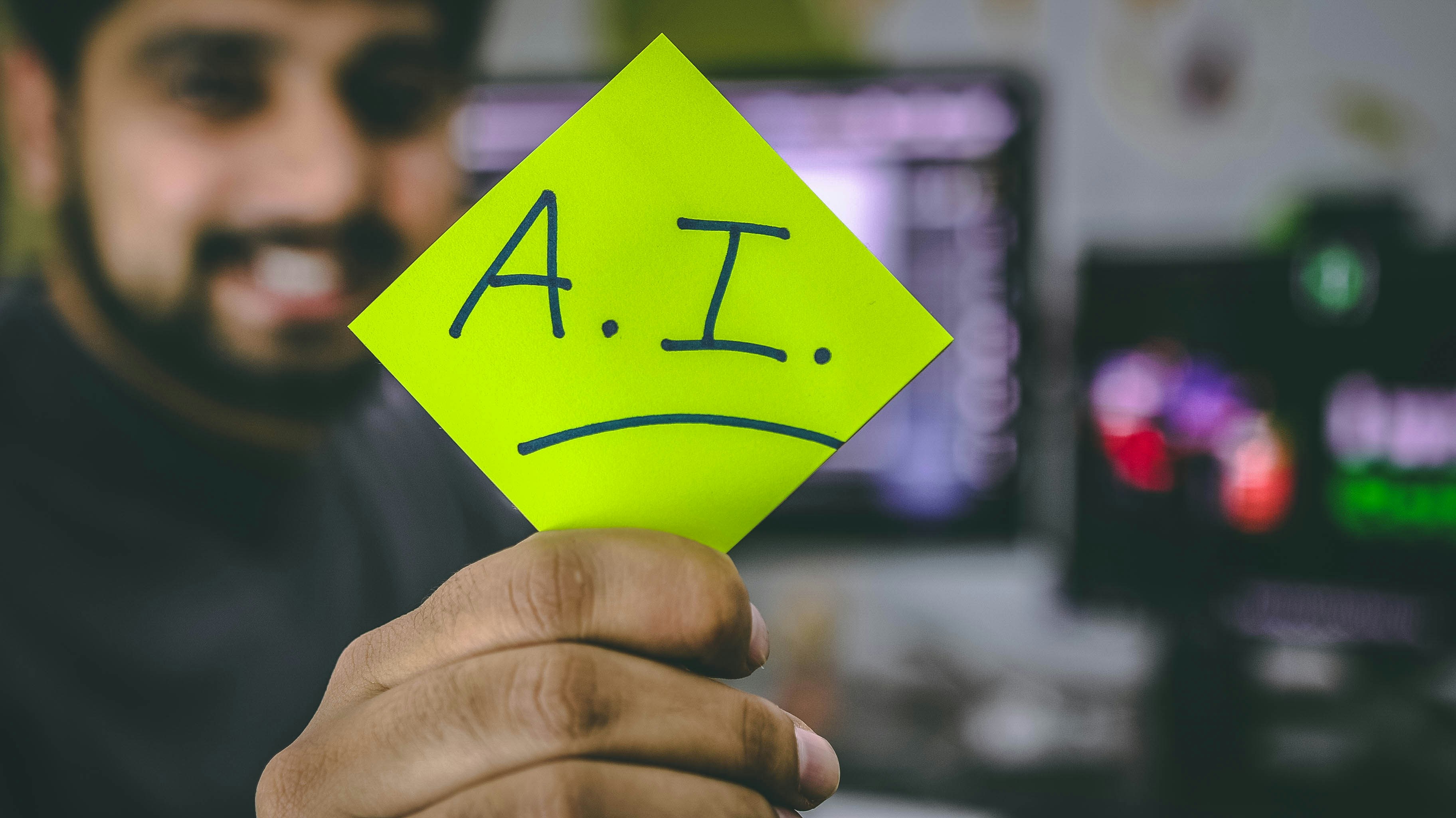 Photo by Unsplash An illustrative photo of a person holding a green piece of paper.