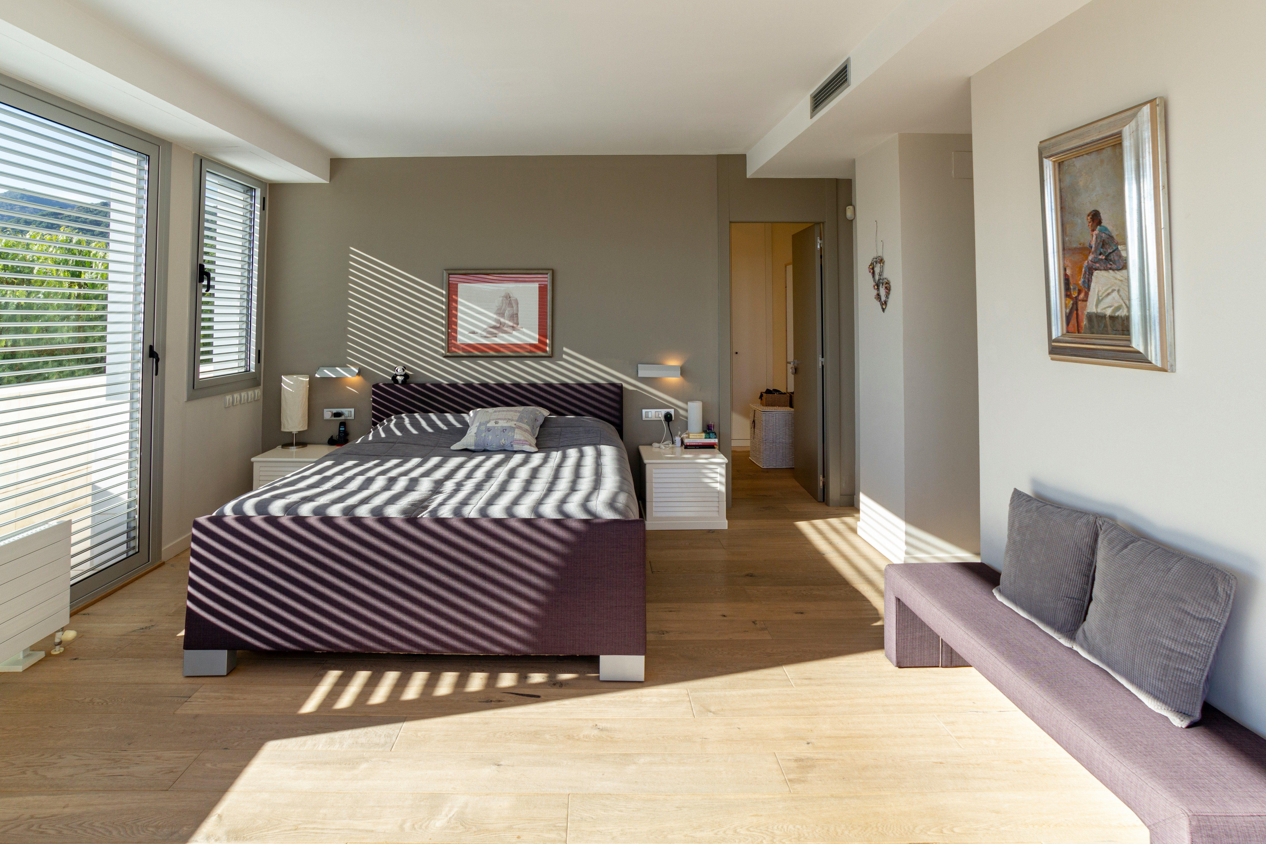 An illustrative photo of a bedroom with a bed and a couch in it