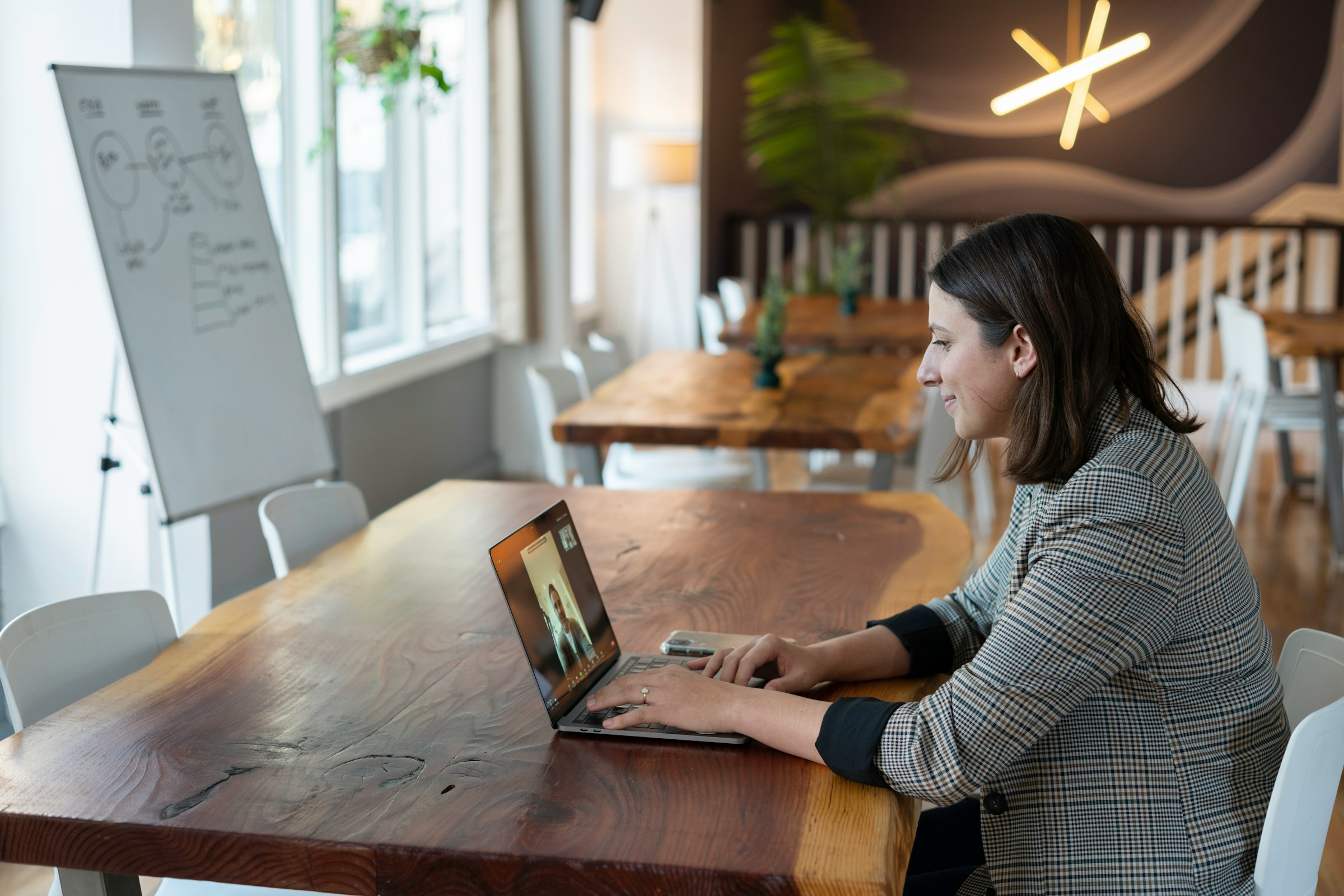 An illustrative photo of a woman sitting at a table.