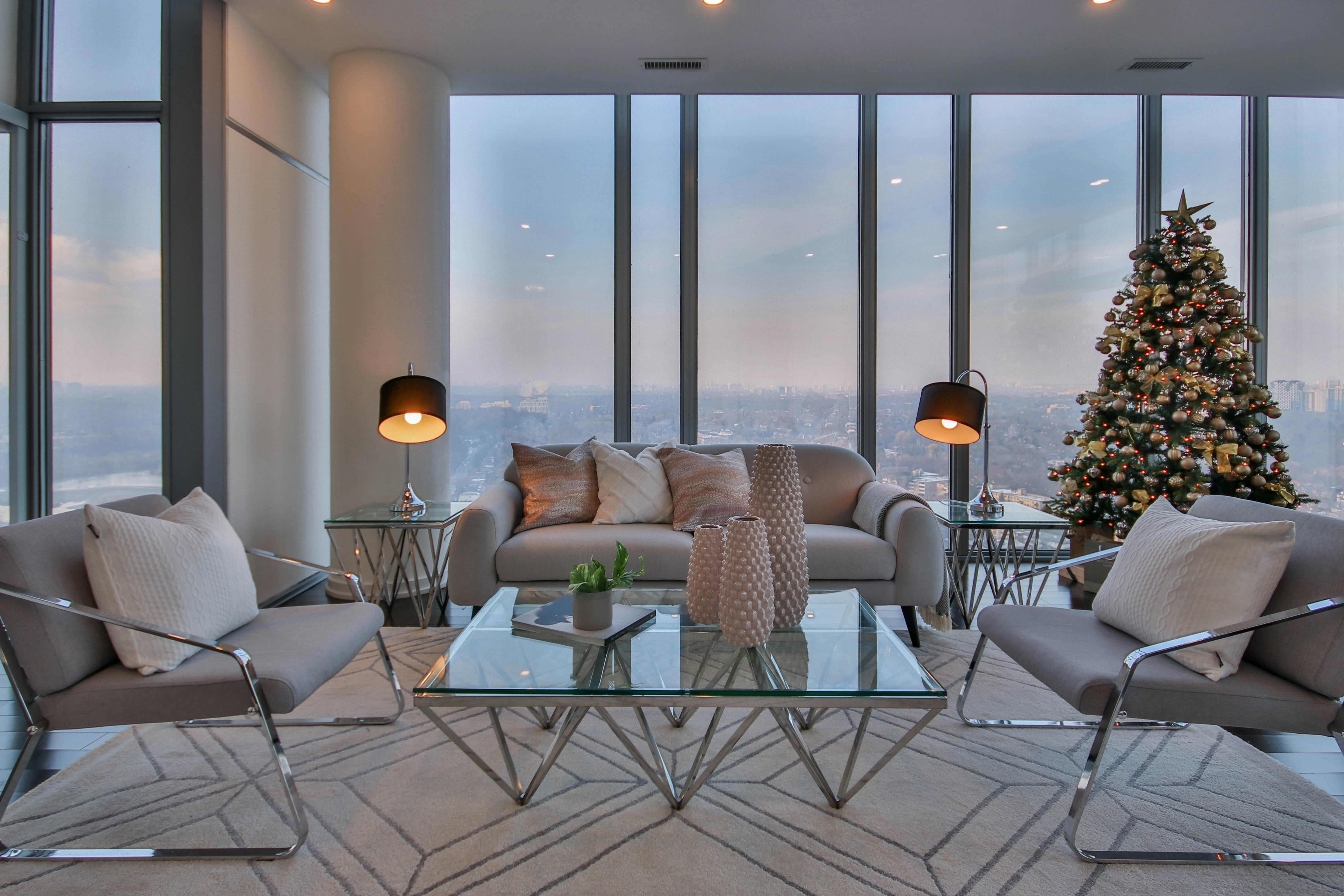 An illustrative photo of a living room filled with furniture and a christmas tree.