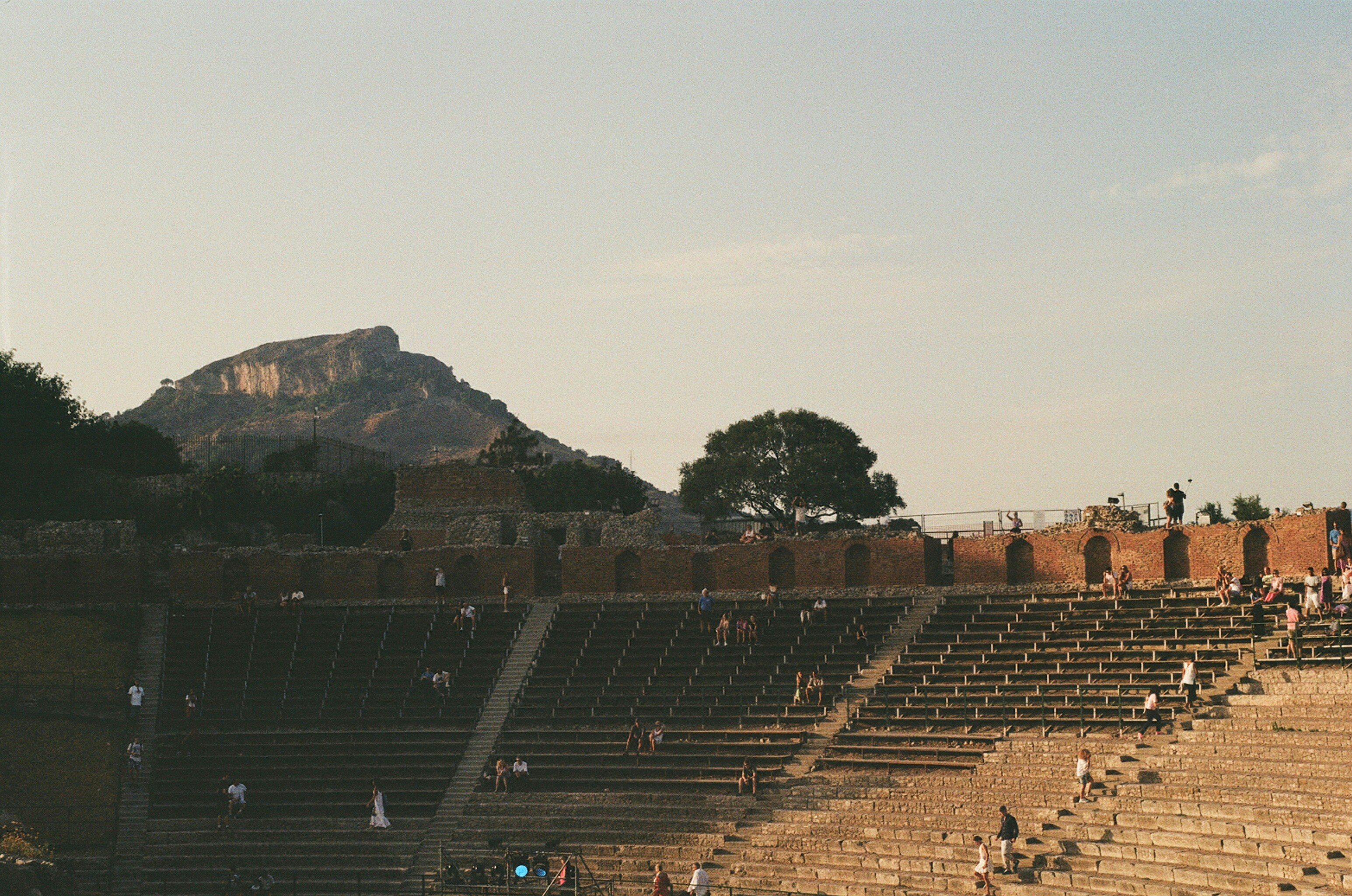 An illustrative photo of an ancient stadium with people.