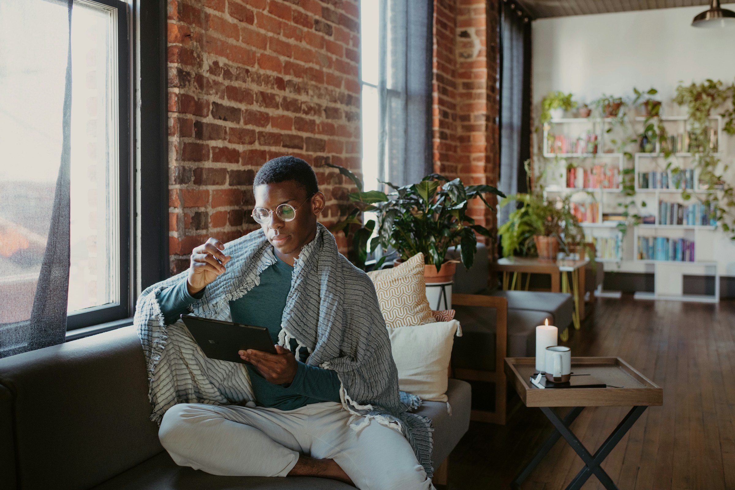 An illustrative photo of a person sitting on a couch.