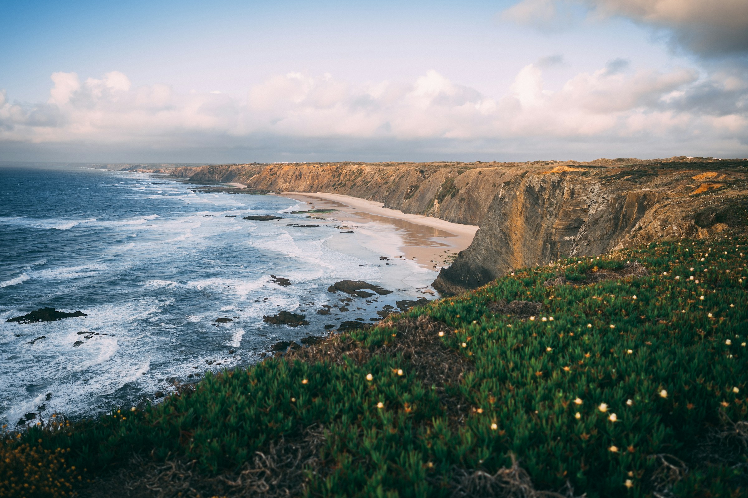 Photo by Unsplash An illustrative photo of a field with green grass on a mountain.