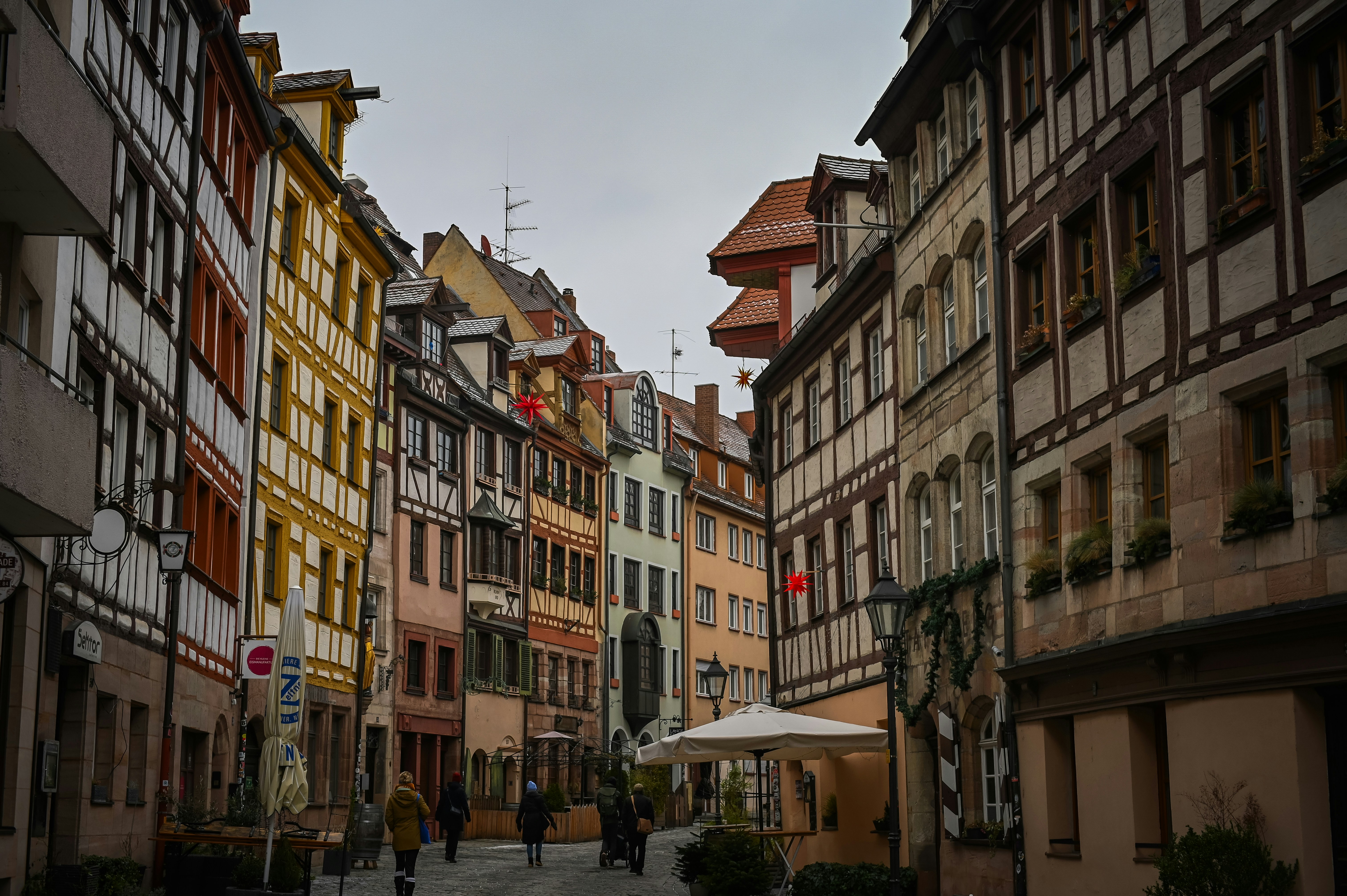 An illustrative photo of people walking on a narrow street in Germany