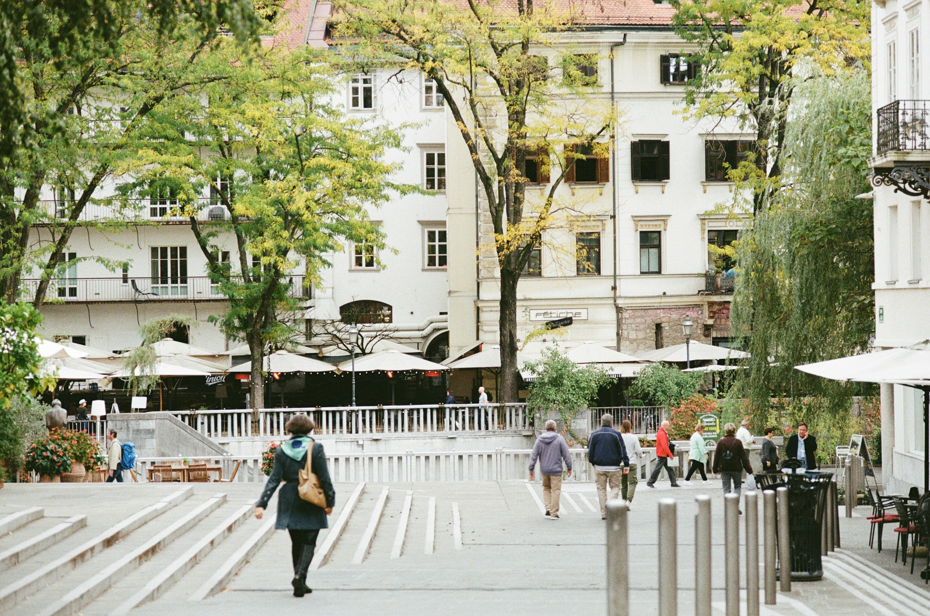 An illustrative photo of people walking on sidewalk in the central district of Ljubljana