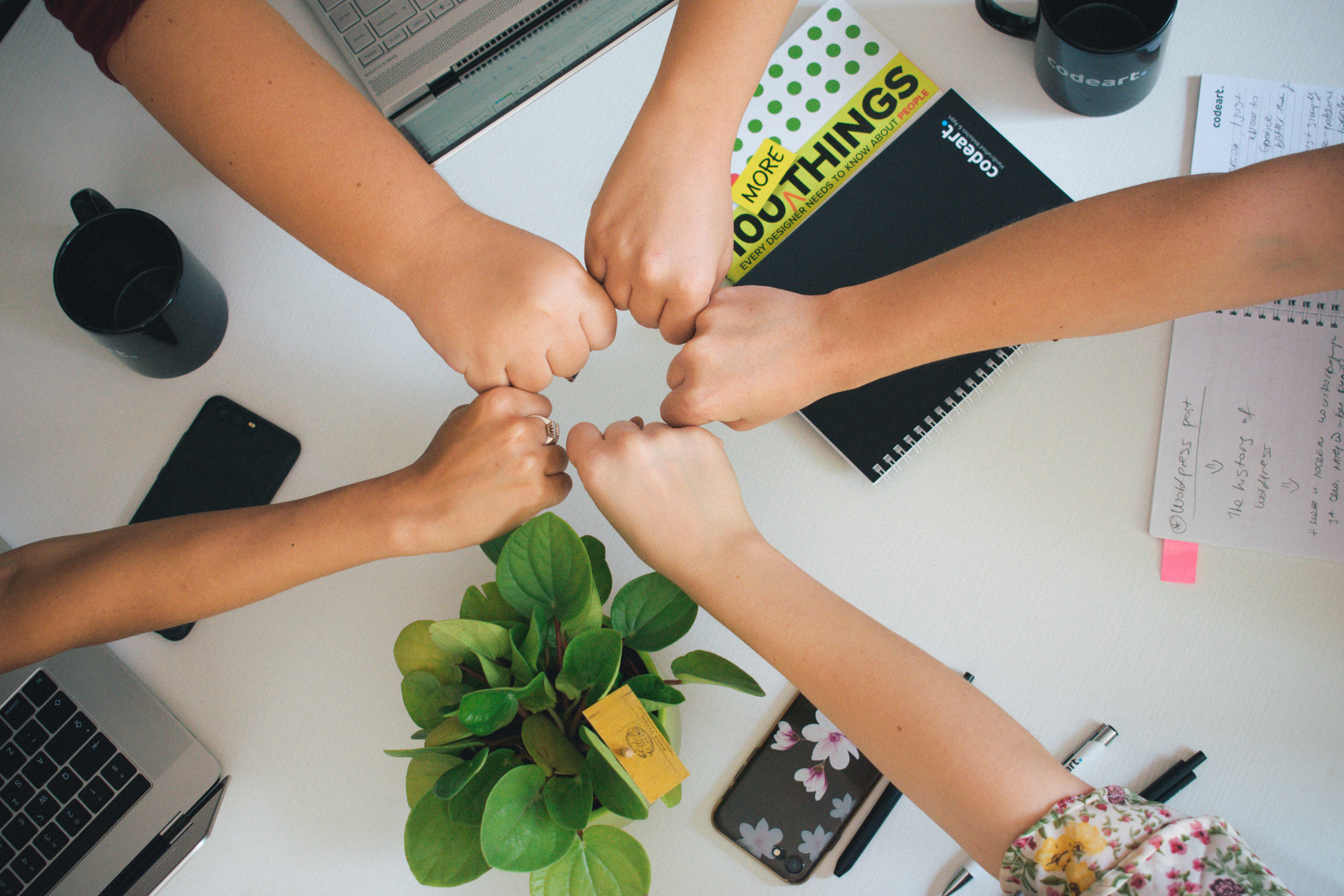 Photo by Unsplash An illustrative photo of people putting hands together as a team
