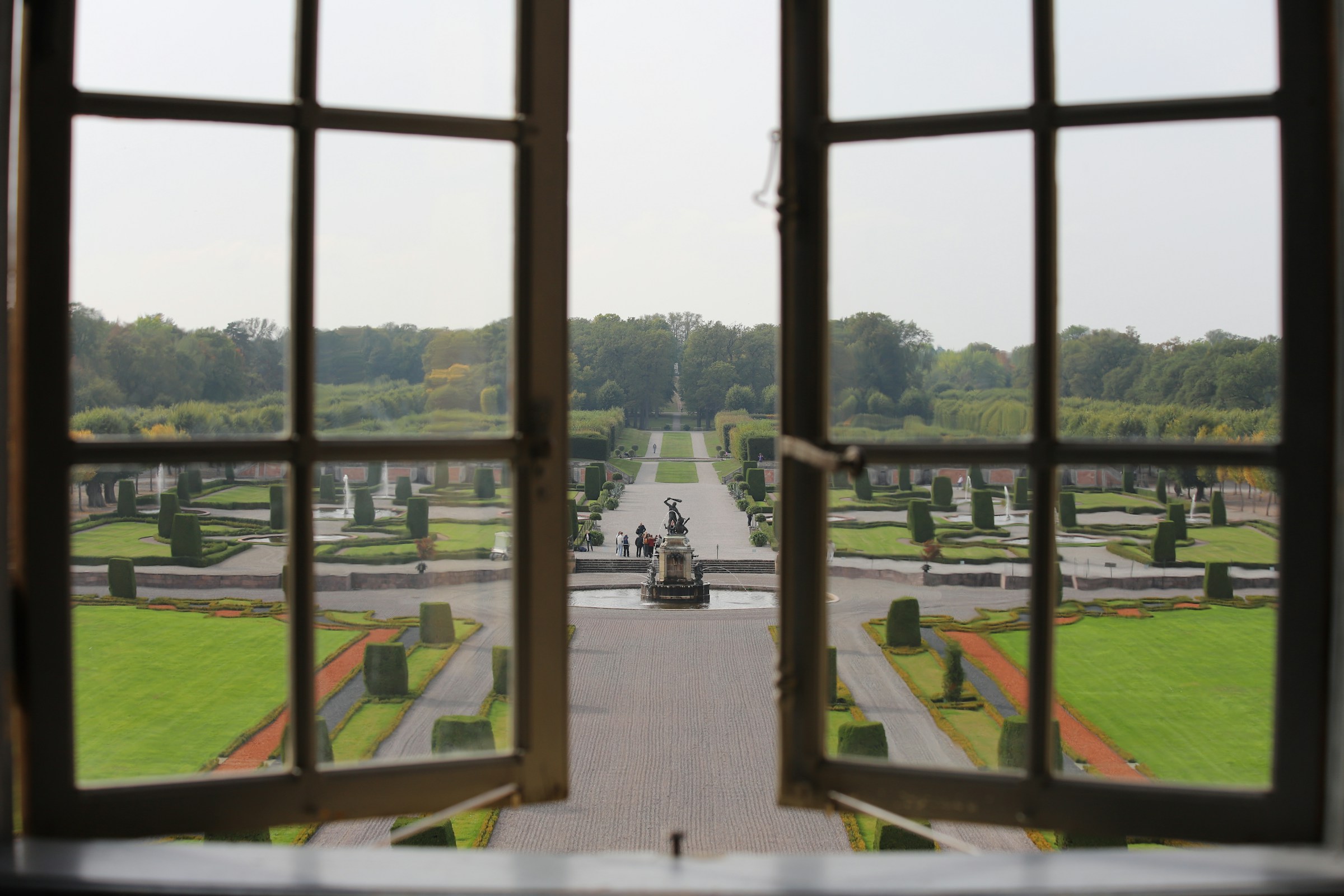 An illustrative photo of an open window with a view of a park.