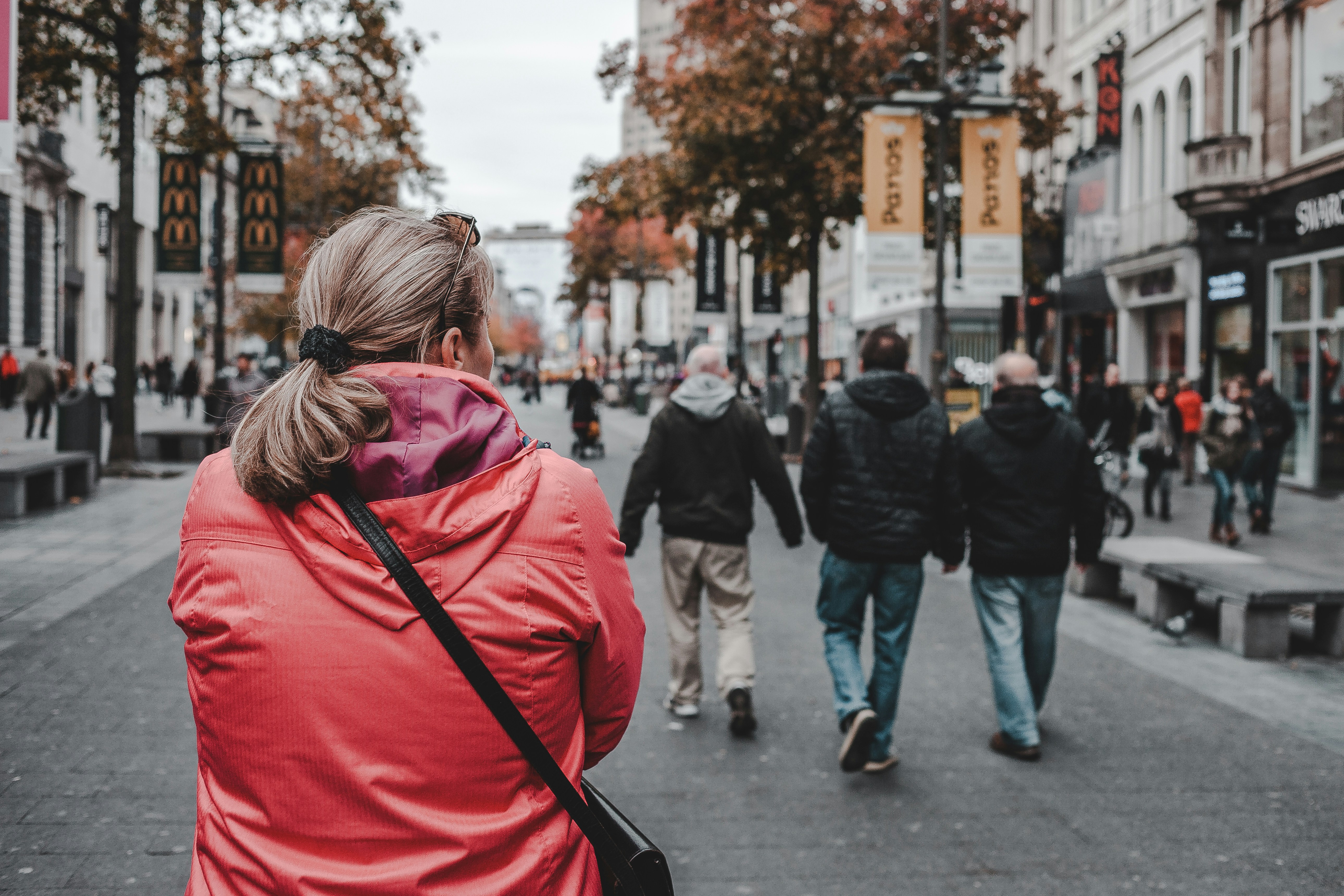 Photo by Unsplash An illustrative photo of a woman walking on a street with many people