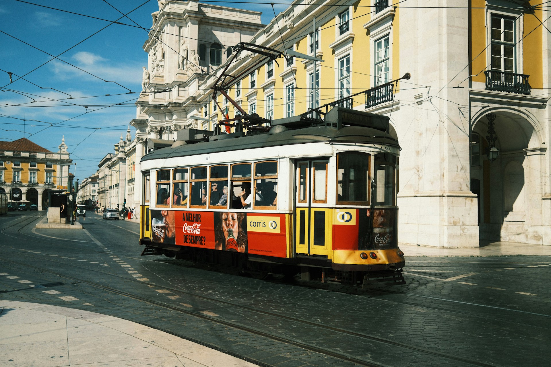 An illustrative photo of a yellow and red trolley car in Lisbon, Portugal