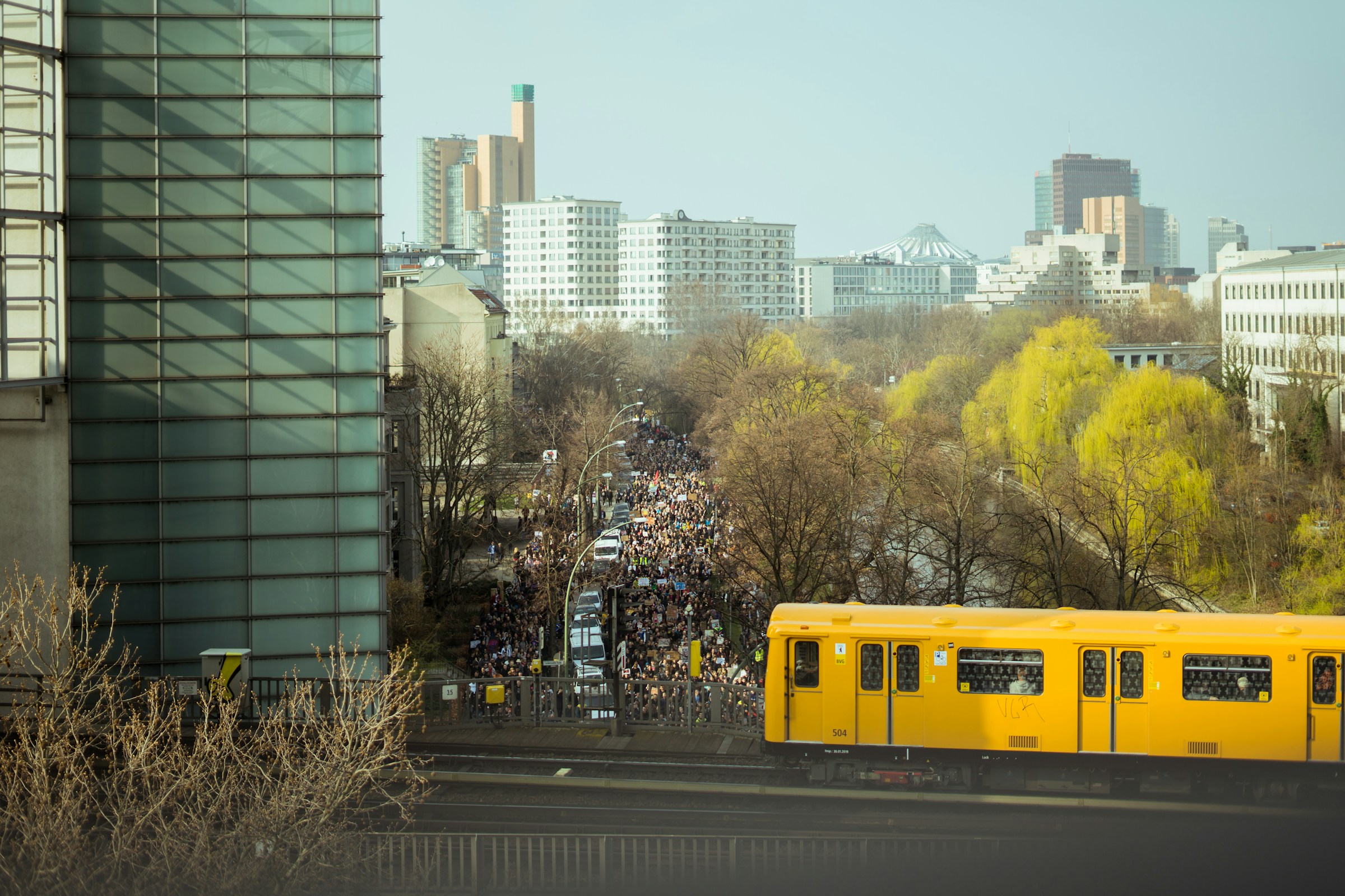 An illustrative photo of yellow train in city.