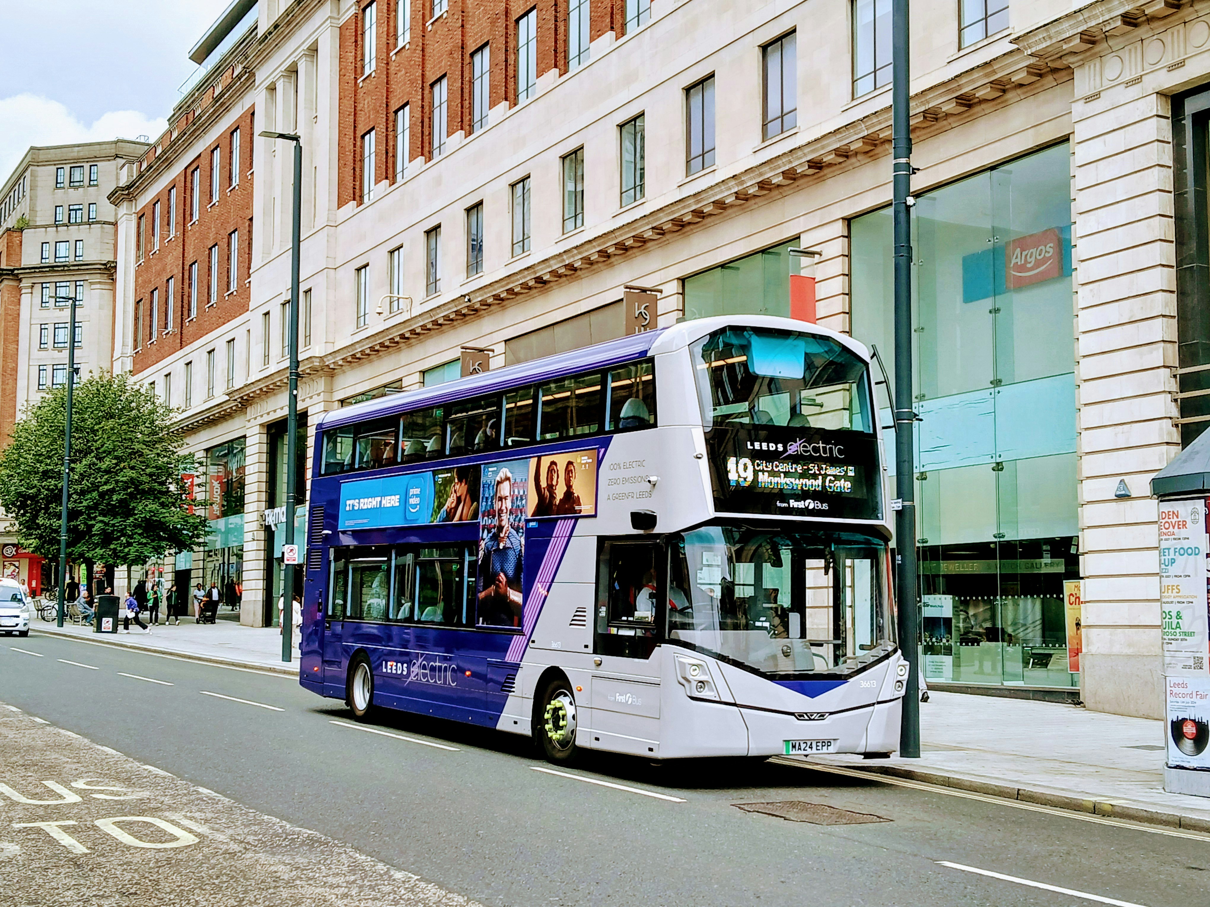 An illustrative photo of a double decker electric bus parked on the side of the street